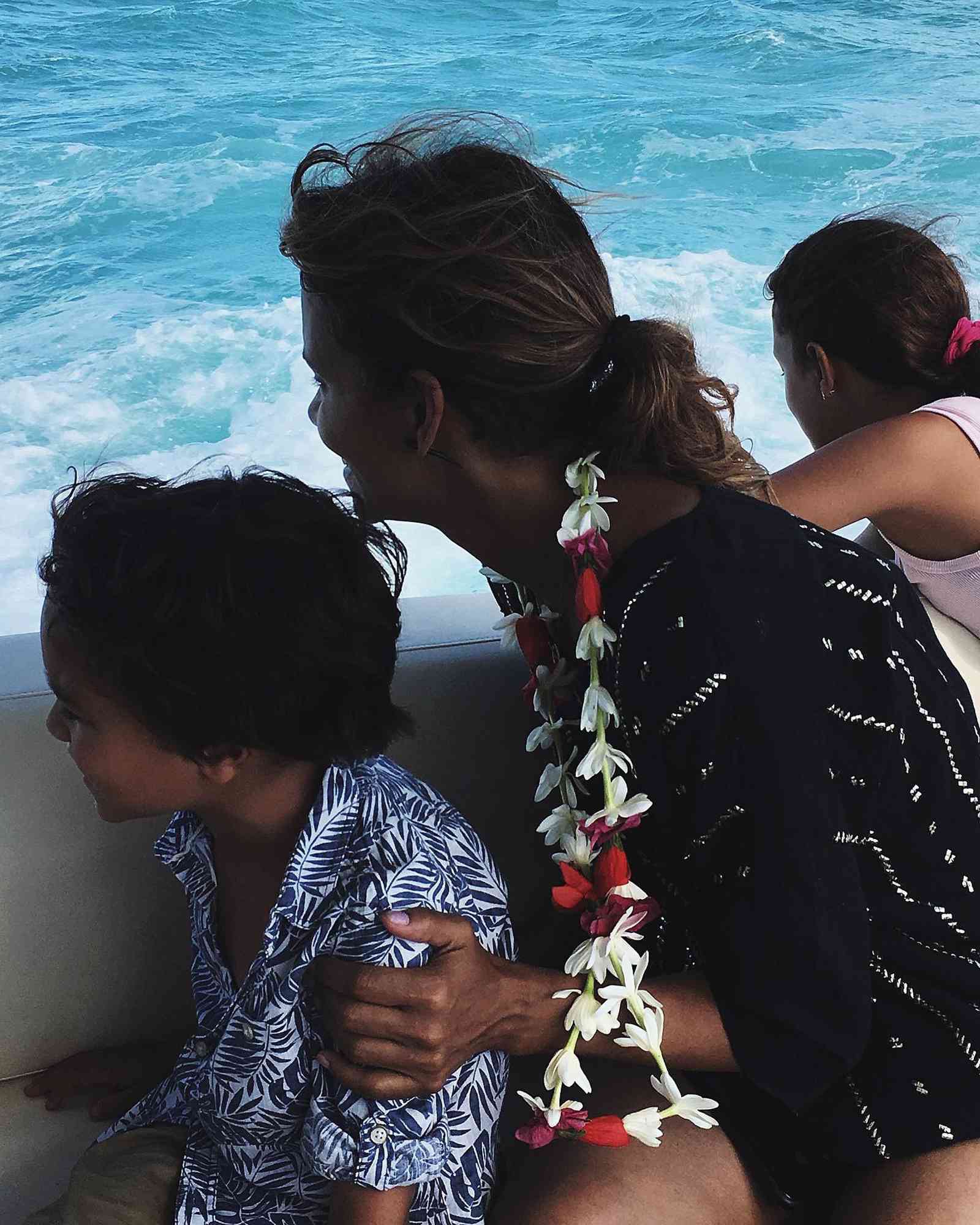 Halle Berry held her young son Maceo close during a family boat trip, wearing a colorful flower lei as they enjoyed the ocean views. | Source: Instagram via @halleberry