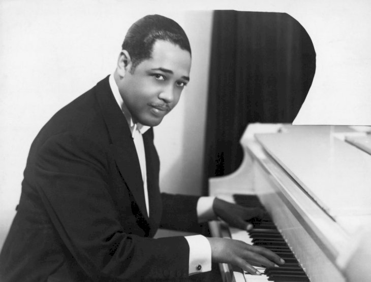 (Original Caption) Duke Ellington (Edward Kennedy; 1889-1974), American composer and arranger, at the keyboard. Half-length photograph, 1910's.