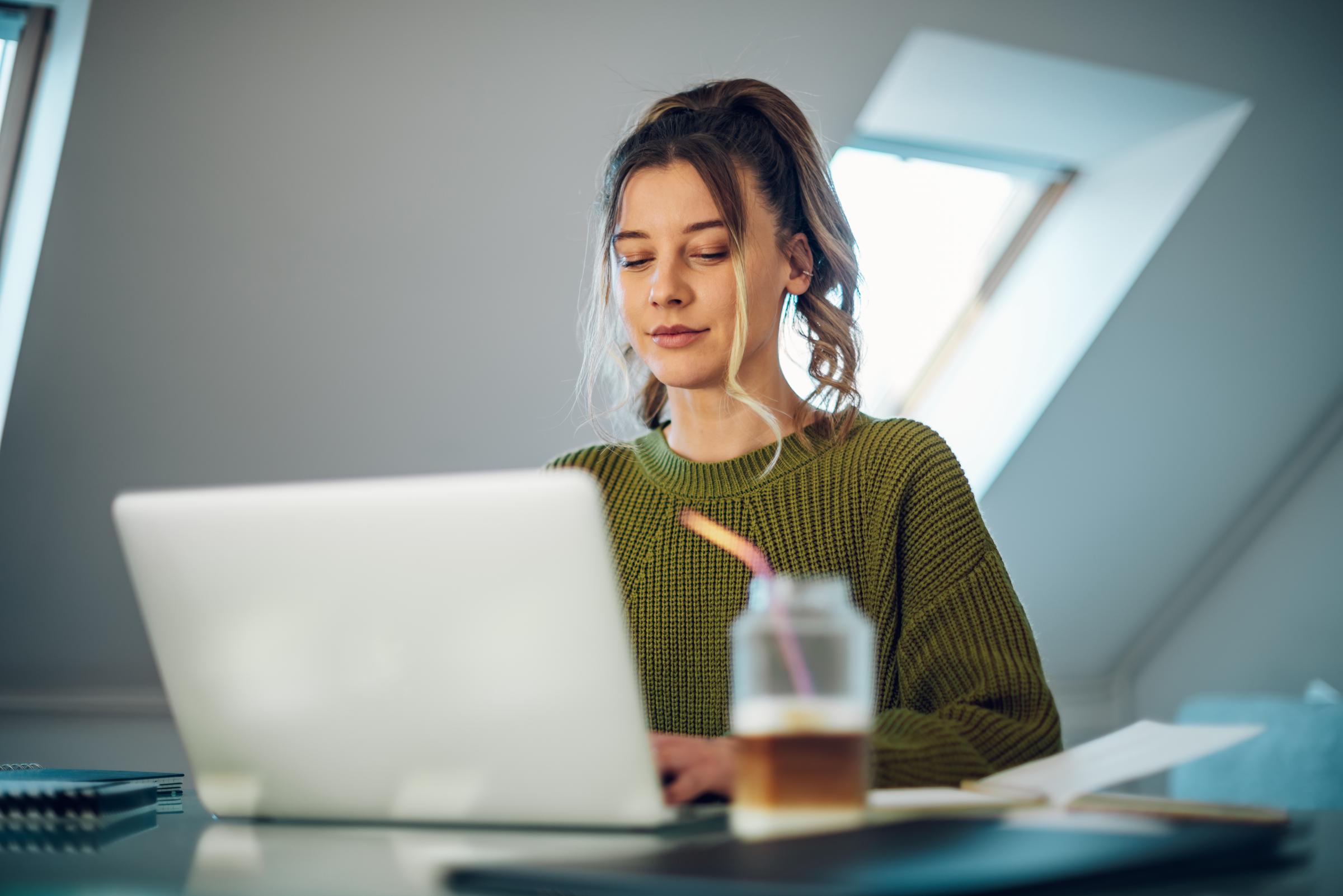 A young woman working peacefully in her home office | Source: Shutterstock