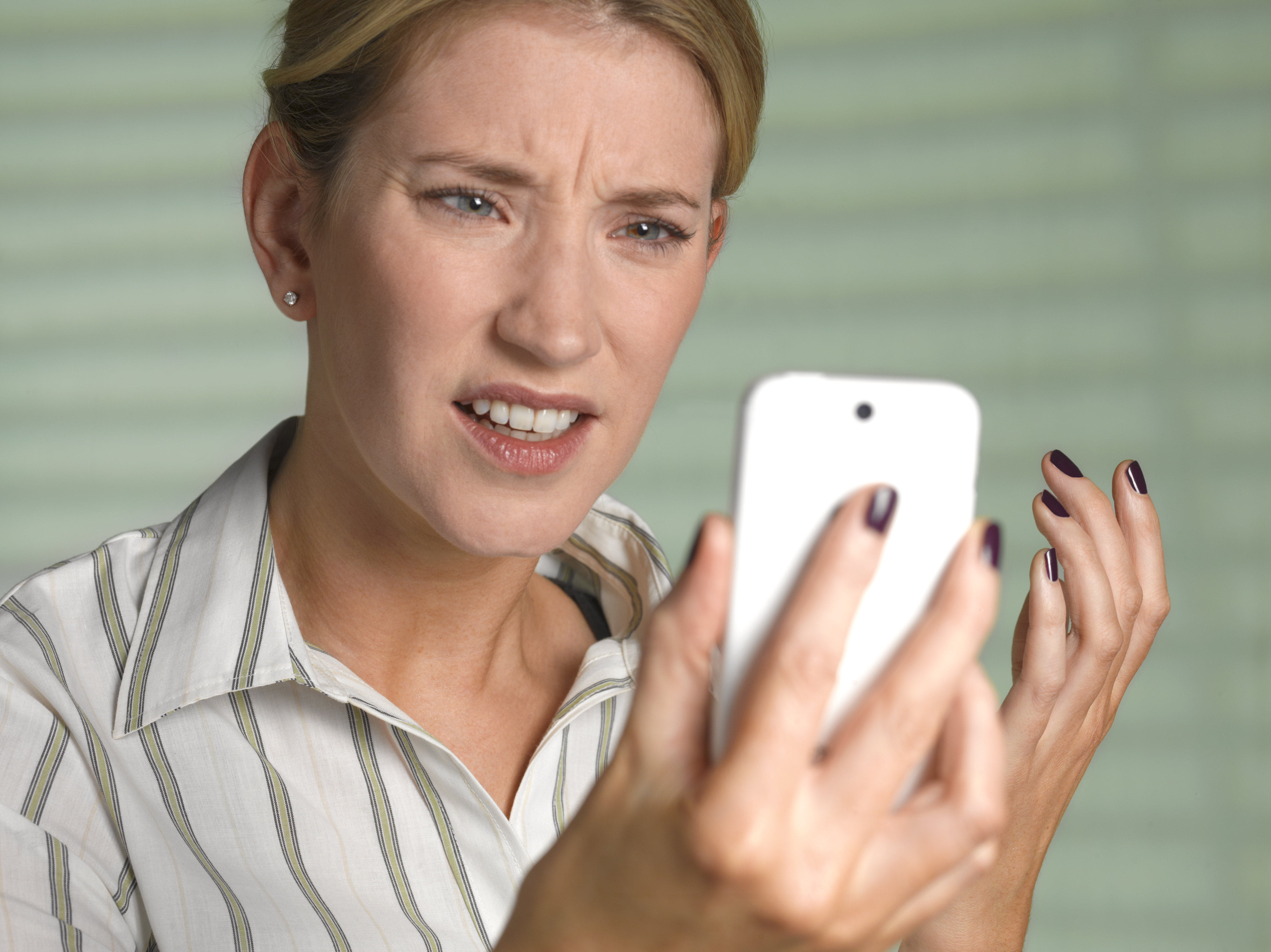 Unhappy woman on smart phone. | Source: Getty Images