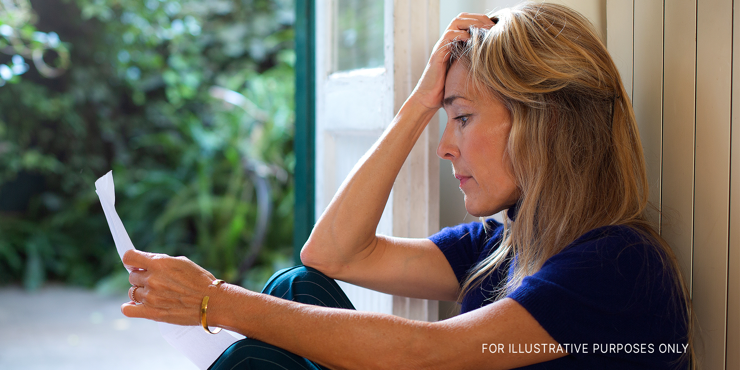 A woman reading a letter | Getty Images