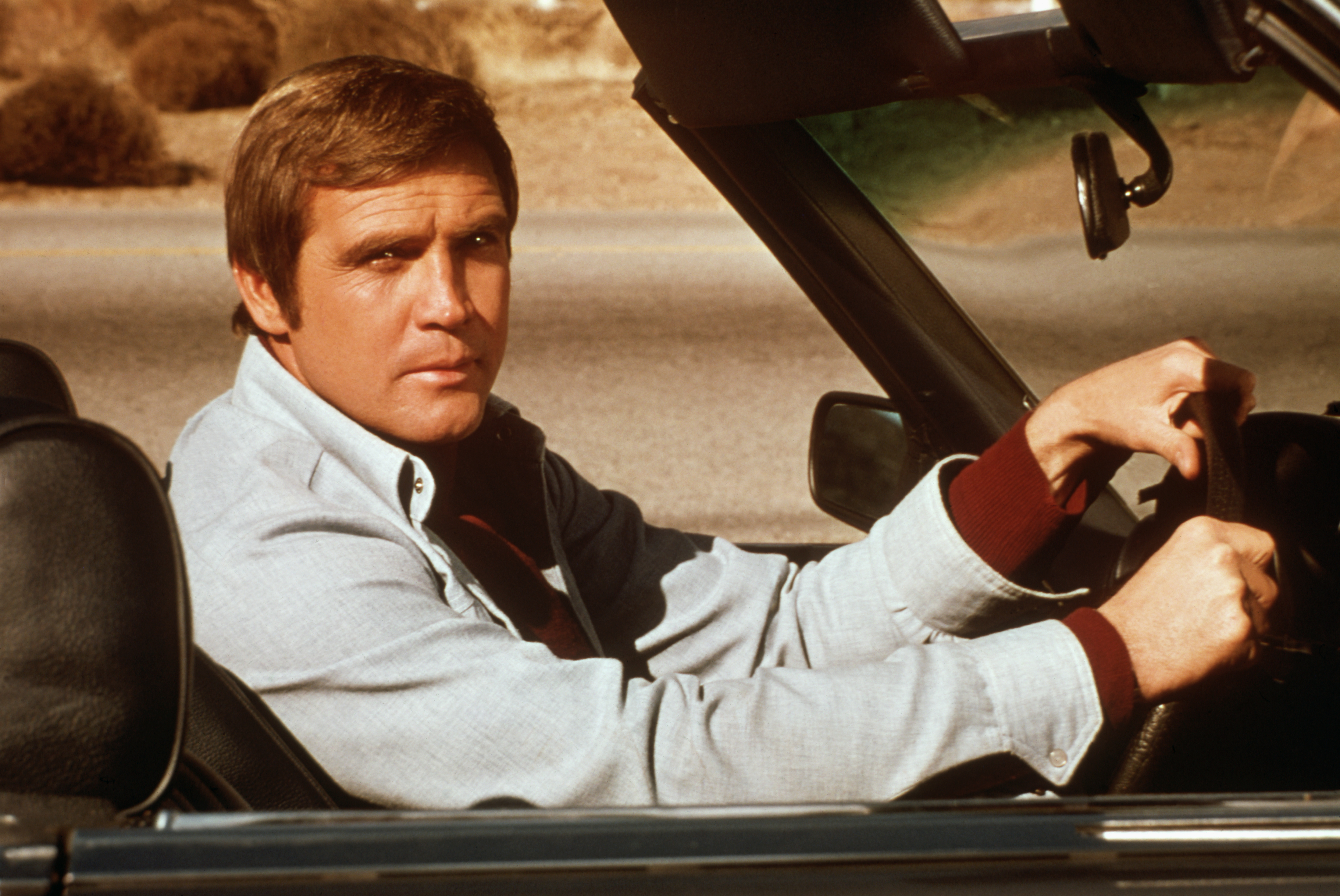 Lee Majors riding in an automobile during a scene from his television show, "The Six Million Dollar Man" in 1973 | Source: Getty Images