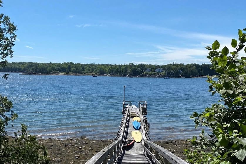 1. A private walkway leads directly to the property's deep-water dock on Sabbathday Harbor, providing access to the surrounding coastal waters. | Source: Facebook/LegacySIR