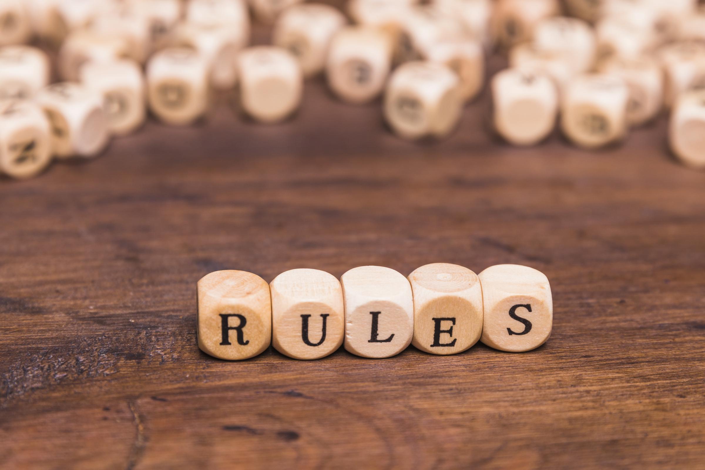 The word Rule written on a wooden cubes | Source: Freepik