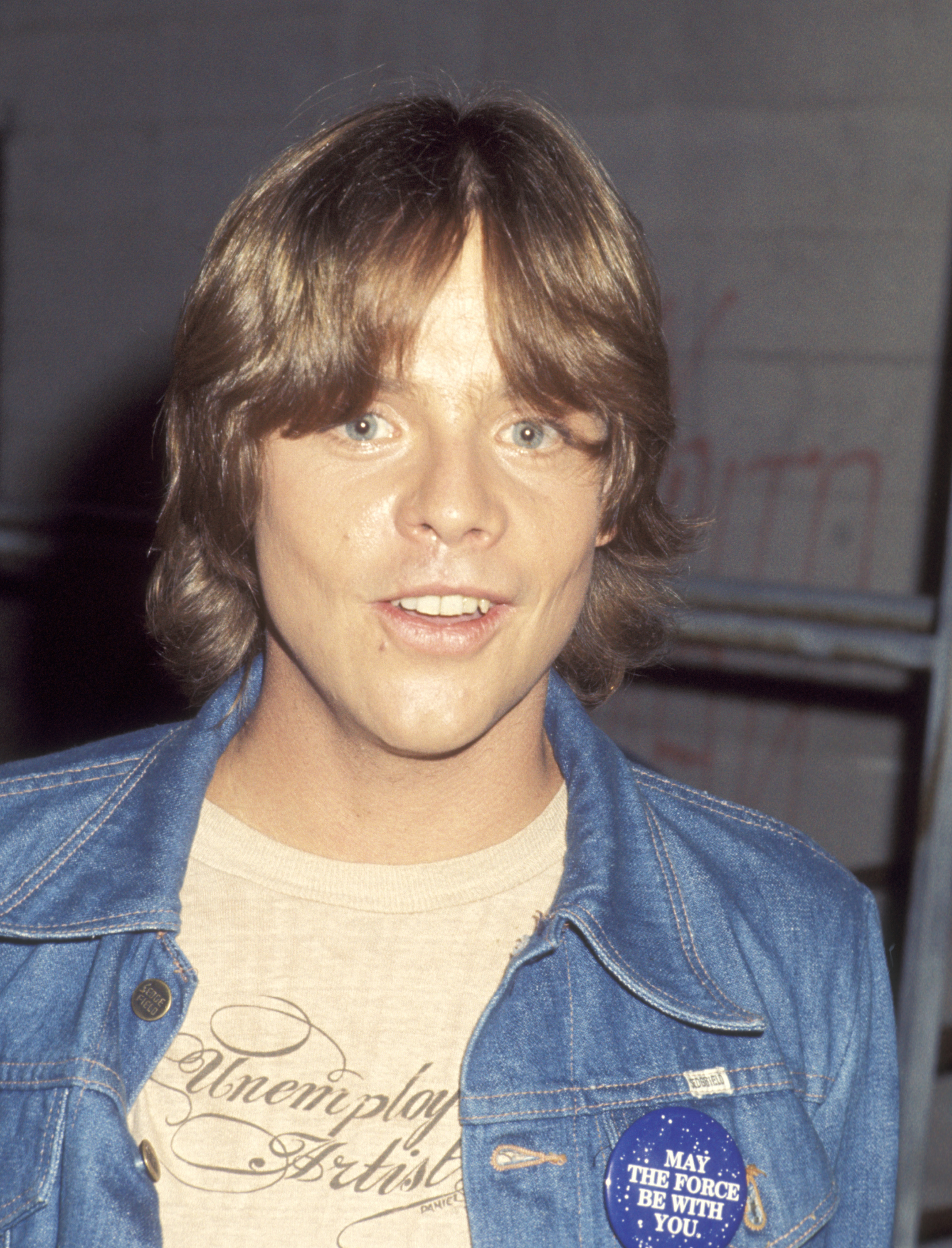 Mark Hamill appeared at a taping of "The Merv Griffin Show" at the TAV Celebrity Theater in Hollywood, California, on June 7, 1977, just weeks after "Star Wars" reached theaters. Wearing a denim jacket with a "May the Force Be With You" button, Hamill was photographed several months after his car crash and reconstructive treatment. | Source: Getty Images
