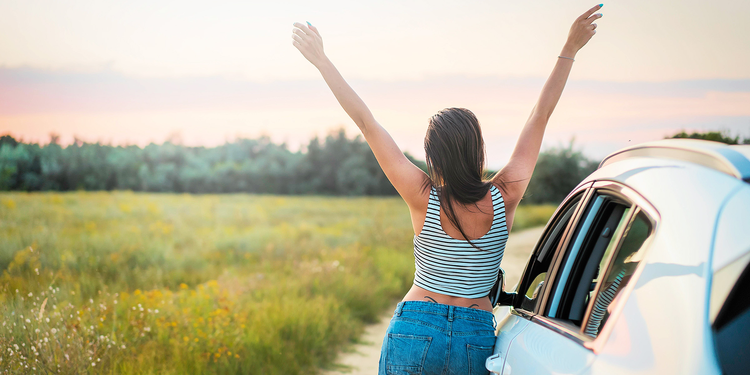 Free spirited woman standing next to a car | Source: Pexels