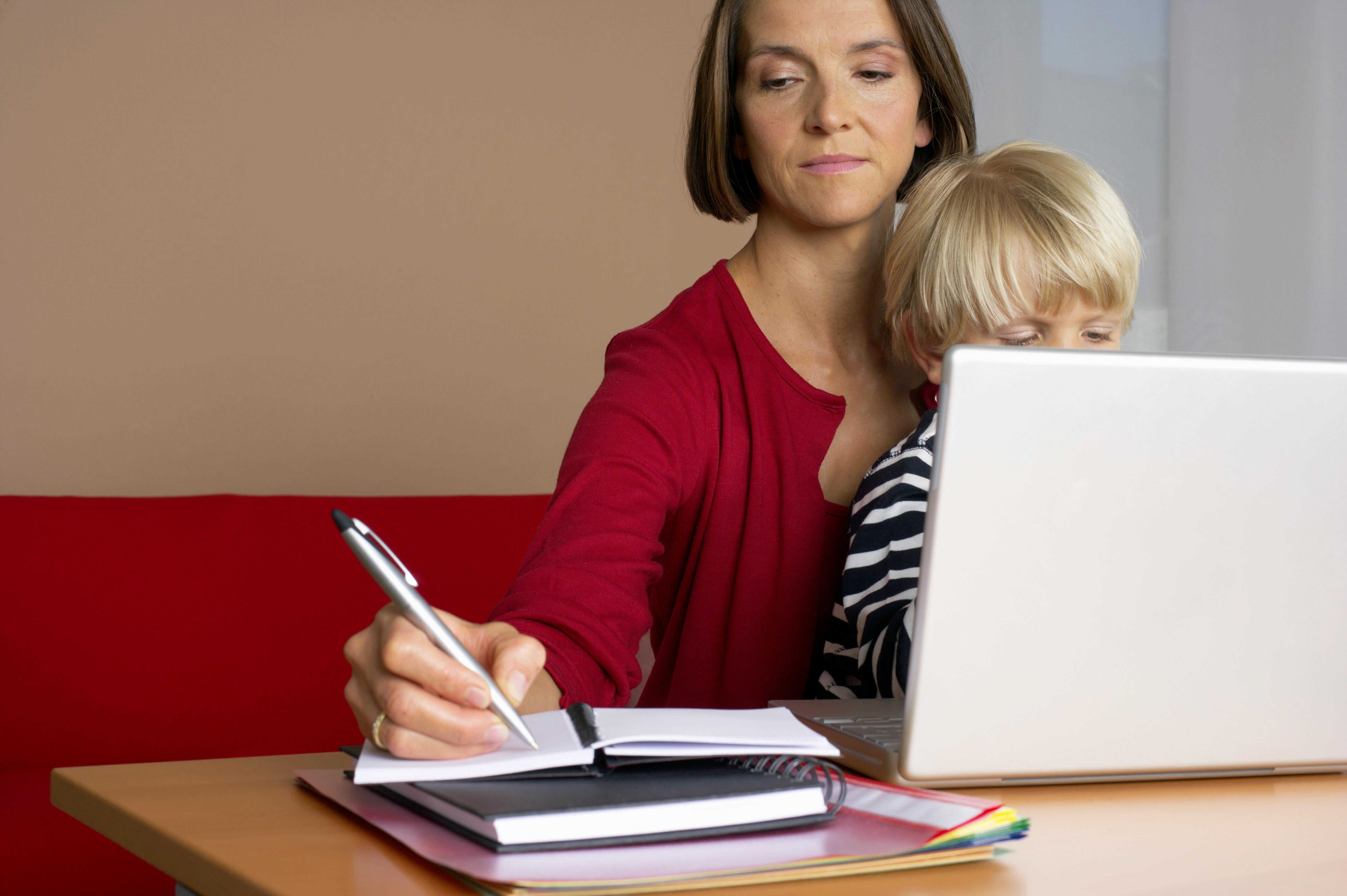 Woman working while bonding with her child | Source: Pexels