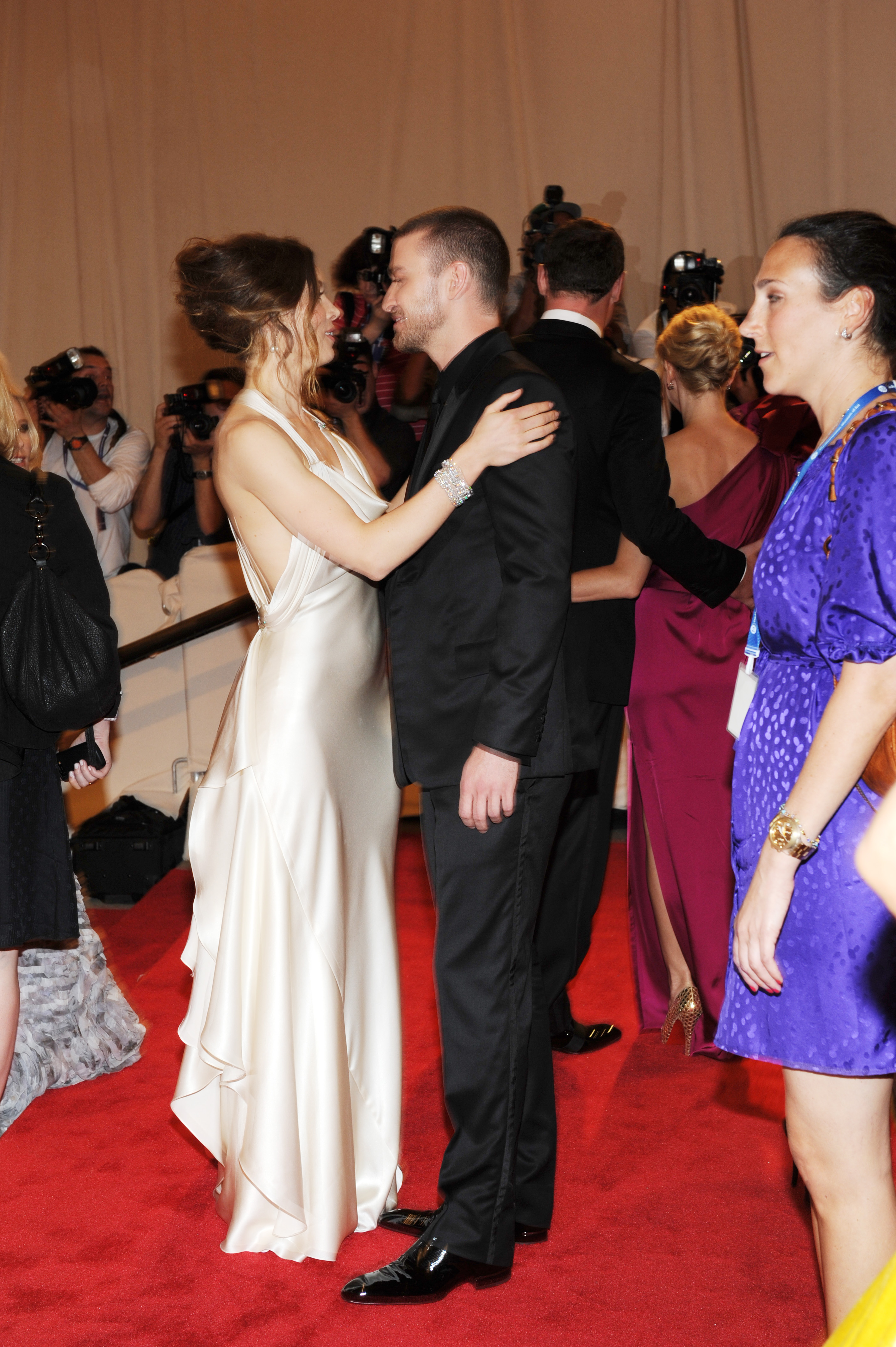 Jessica Biel and Justin Timberlake share a close moment at the Met Costume Institute Gala, with Biel wearing a white Ralph Lauren gown and Timberlake dressed in a black suit. | Source: Getty Images