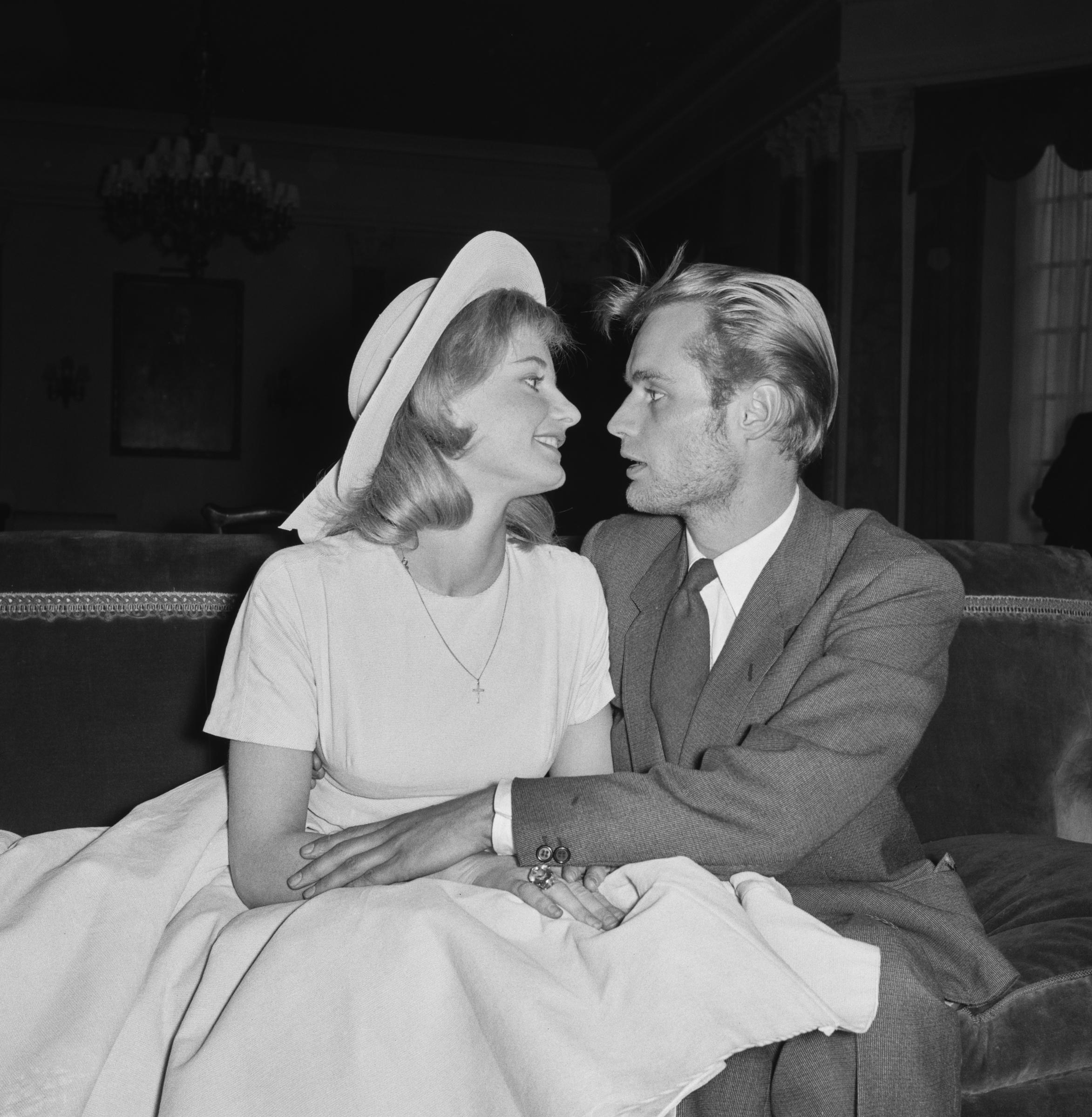 David McCallum holds his wife, Jill Ireland, as they look into each other's eyes on May 13, 1957, just two days after the couple secretly married. | Source: Getty Images