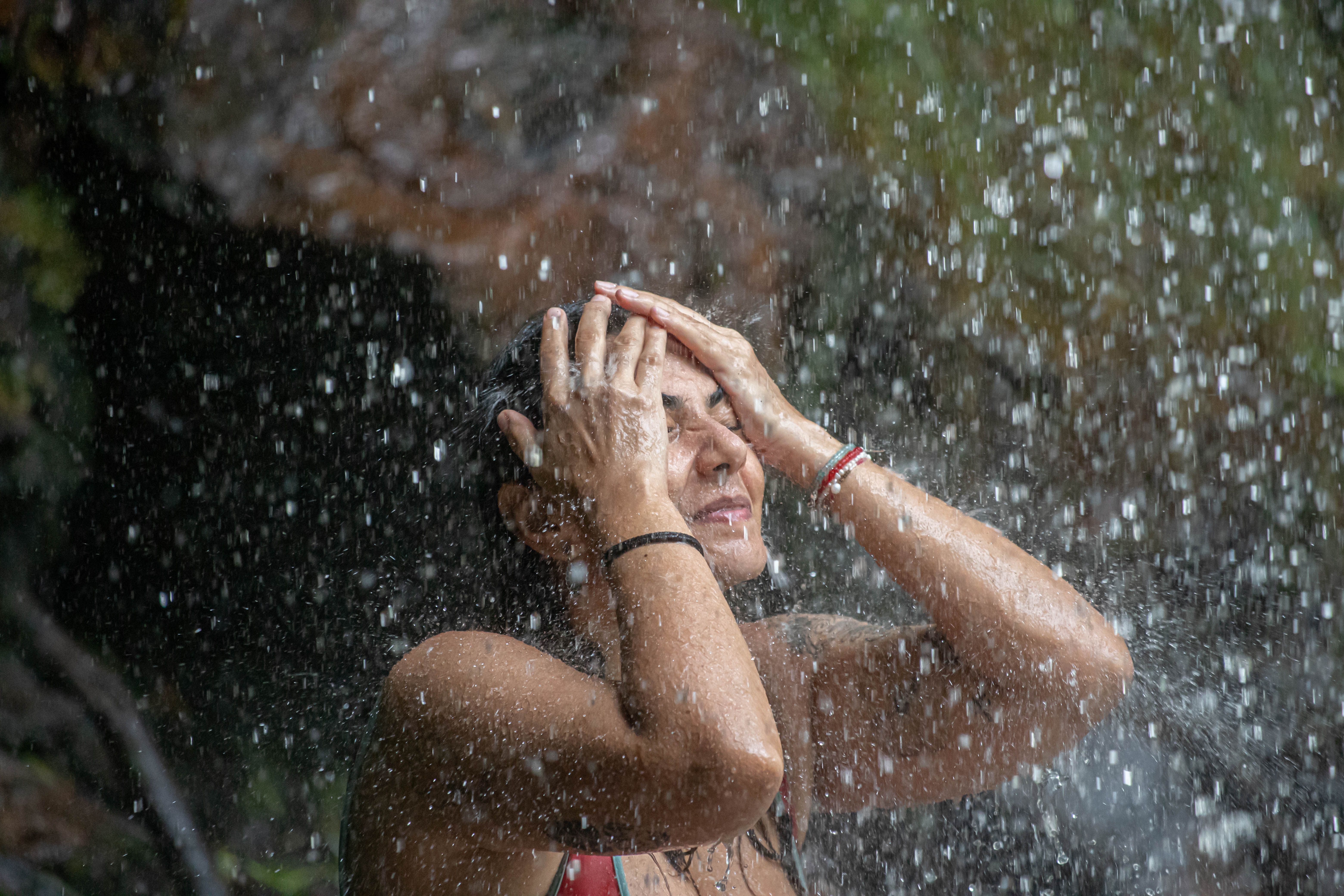 Woman getting soaked in rainwater | Source: Pexels