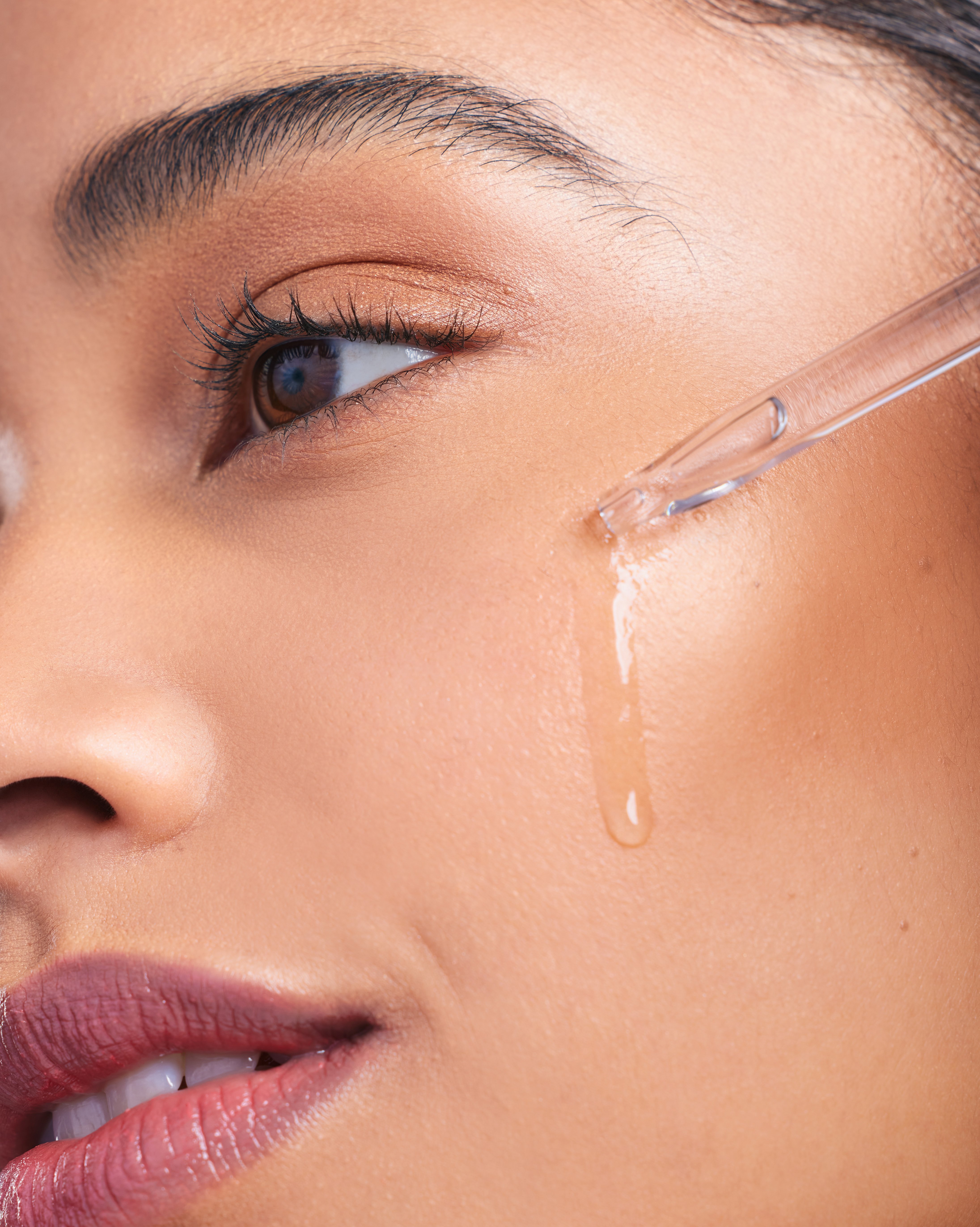 Woman applying a skin-care product. | Source: Getty Images