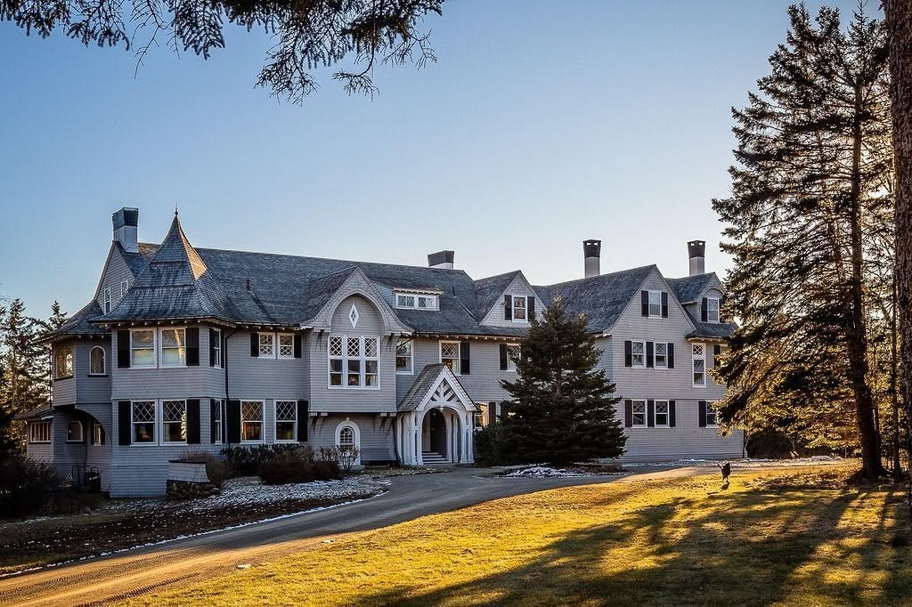The 1903 shingle-style home stands amid mature trees on more than 48 acres of oceanfront land on Maine's Islesboro island. | Source: Facebook/LegacySIR