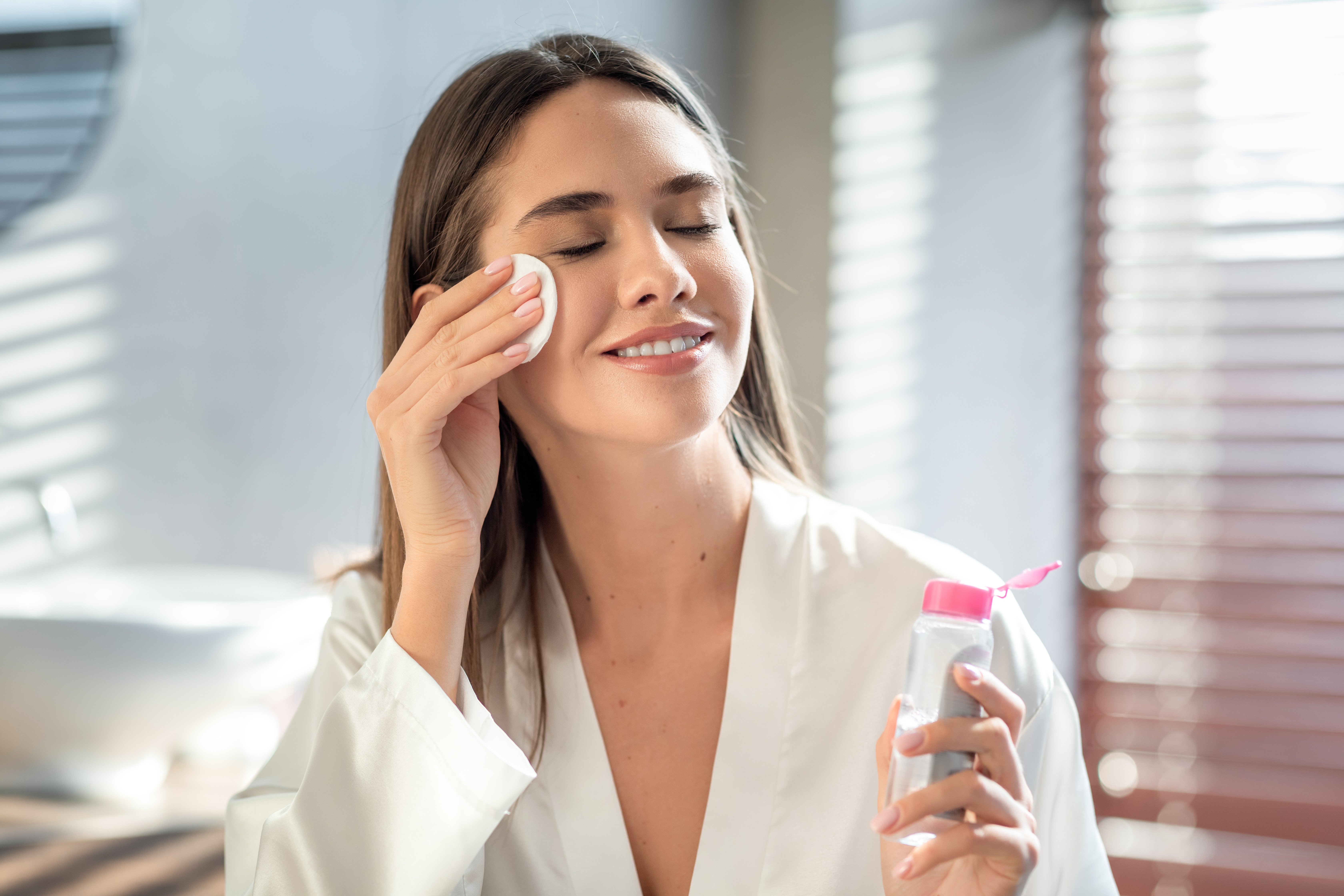 A photo of a woman cleansing her face | Source: Shutterstock