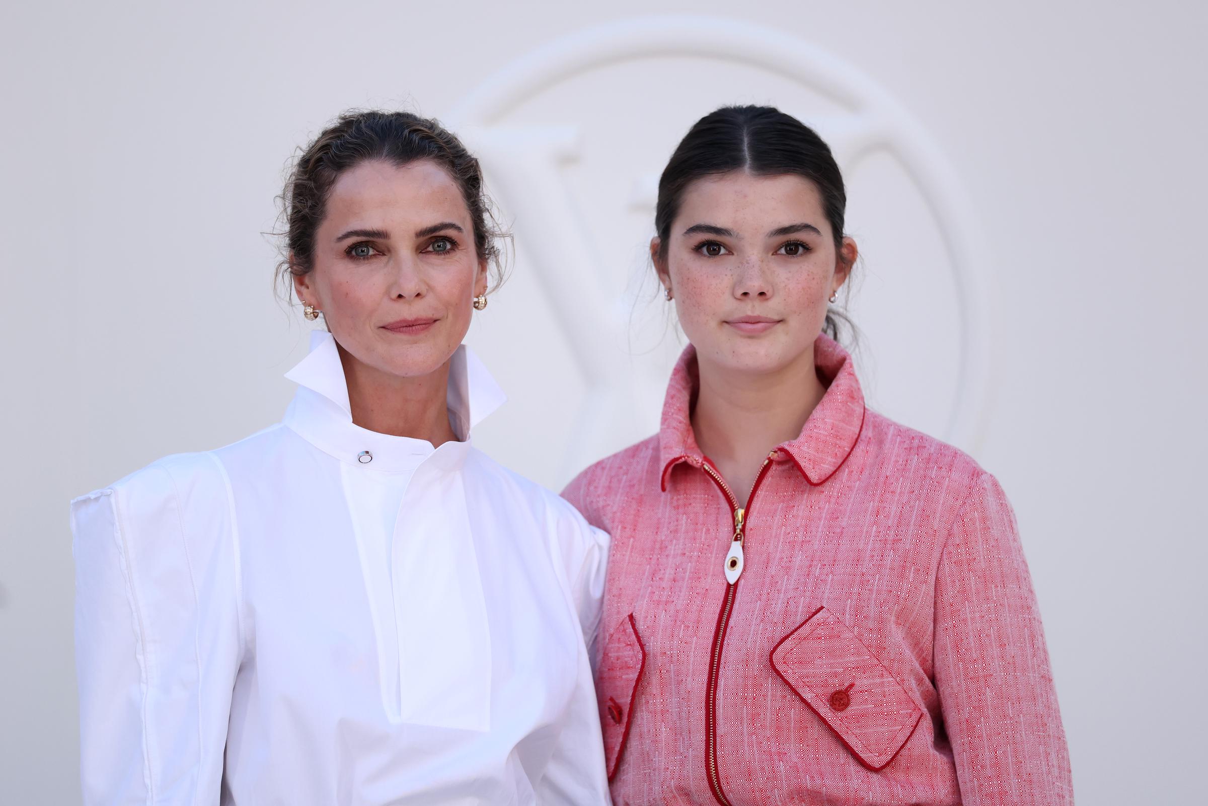 This close-up gives the clearest view of their side-by-side features, with the daughter’s natural freckles, minimal makeup, and sleek ponytail standing out against her mother’s more sculpted fashion-week styling. | Source: Getty Images