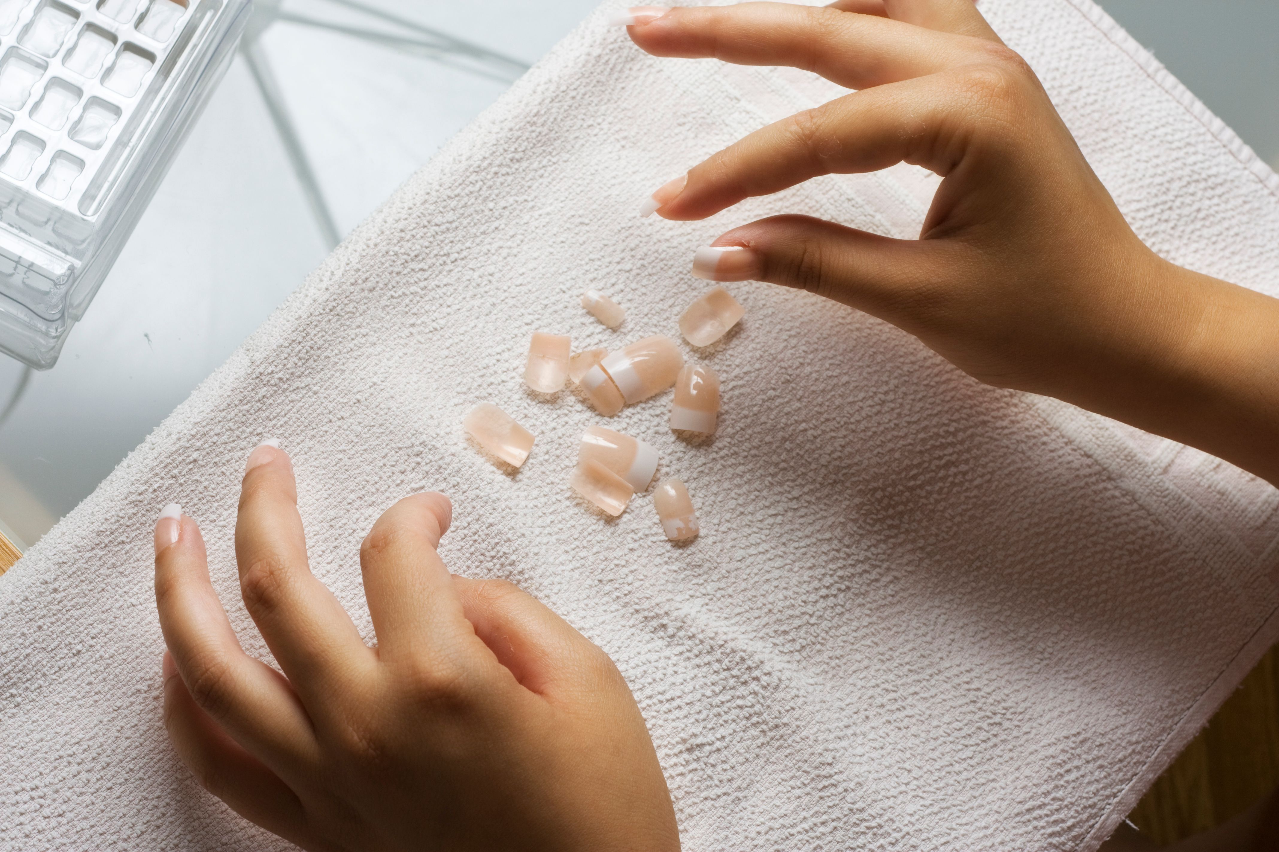 Stick-on nails scattered on the table. | Source: Getty Images