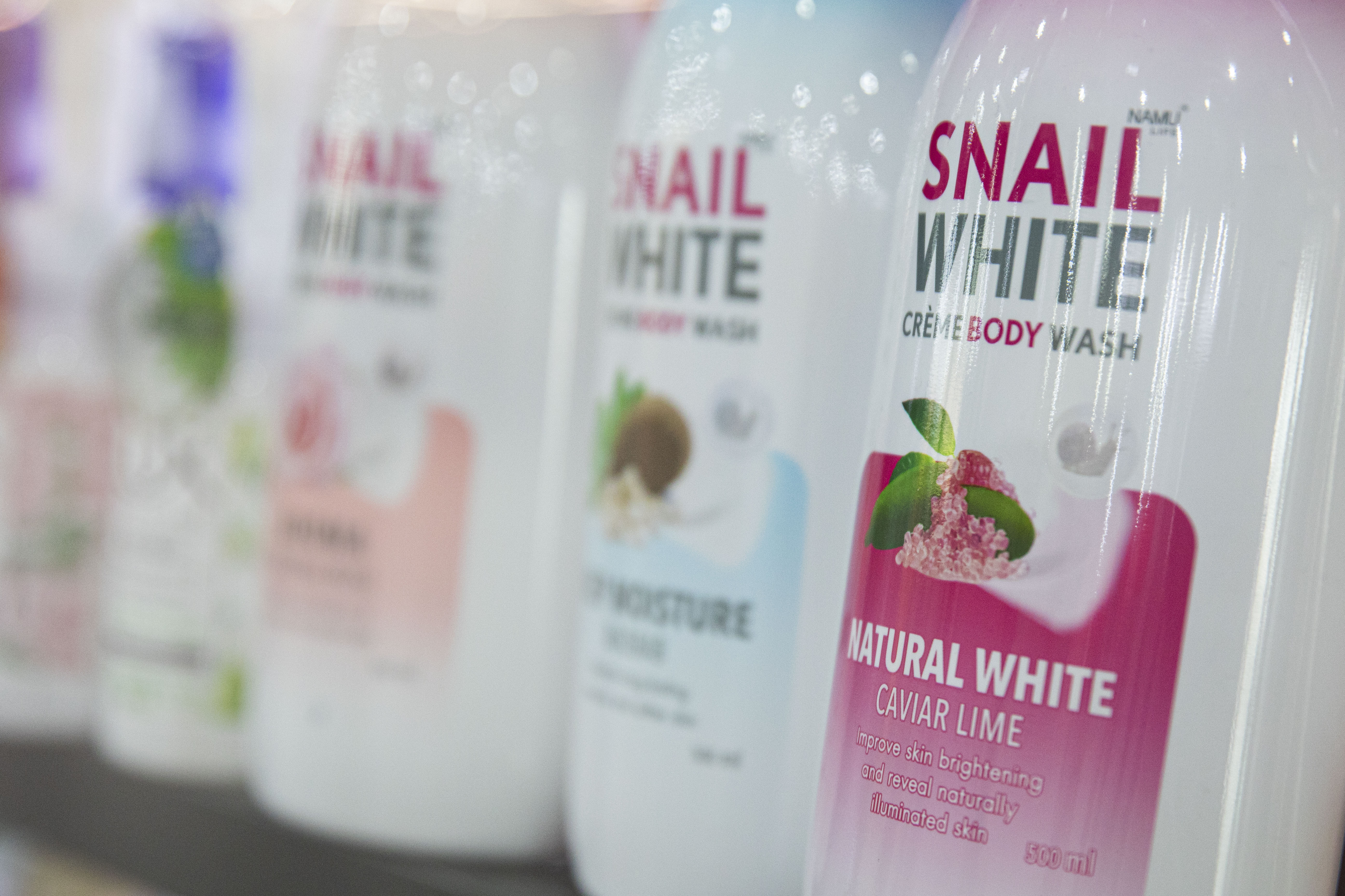 Bottles of Namu Life Snail White Creme Body Wash pictured on the shelf of a cosmetics store on September 5, 2021 in Bangkok, Thailand | Source: Getty Images