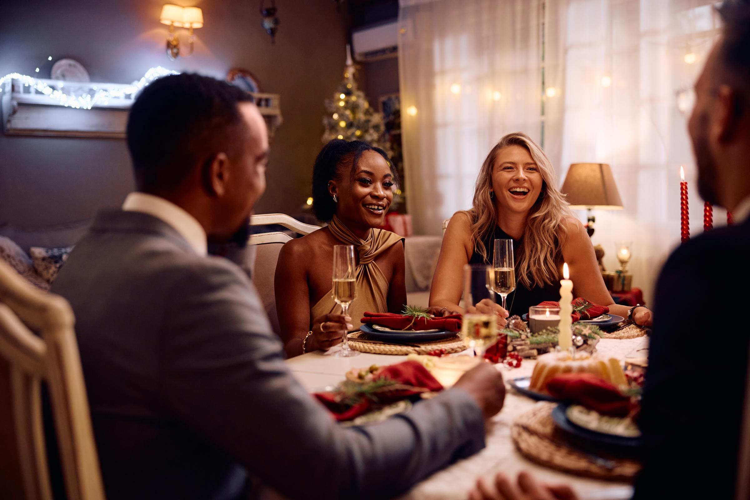 A group of friends at a dinner table | Source: Shutterstock