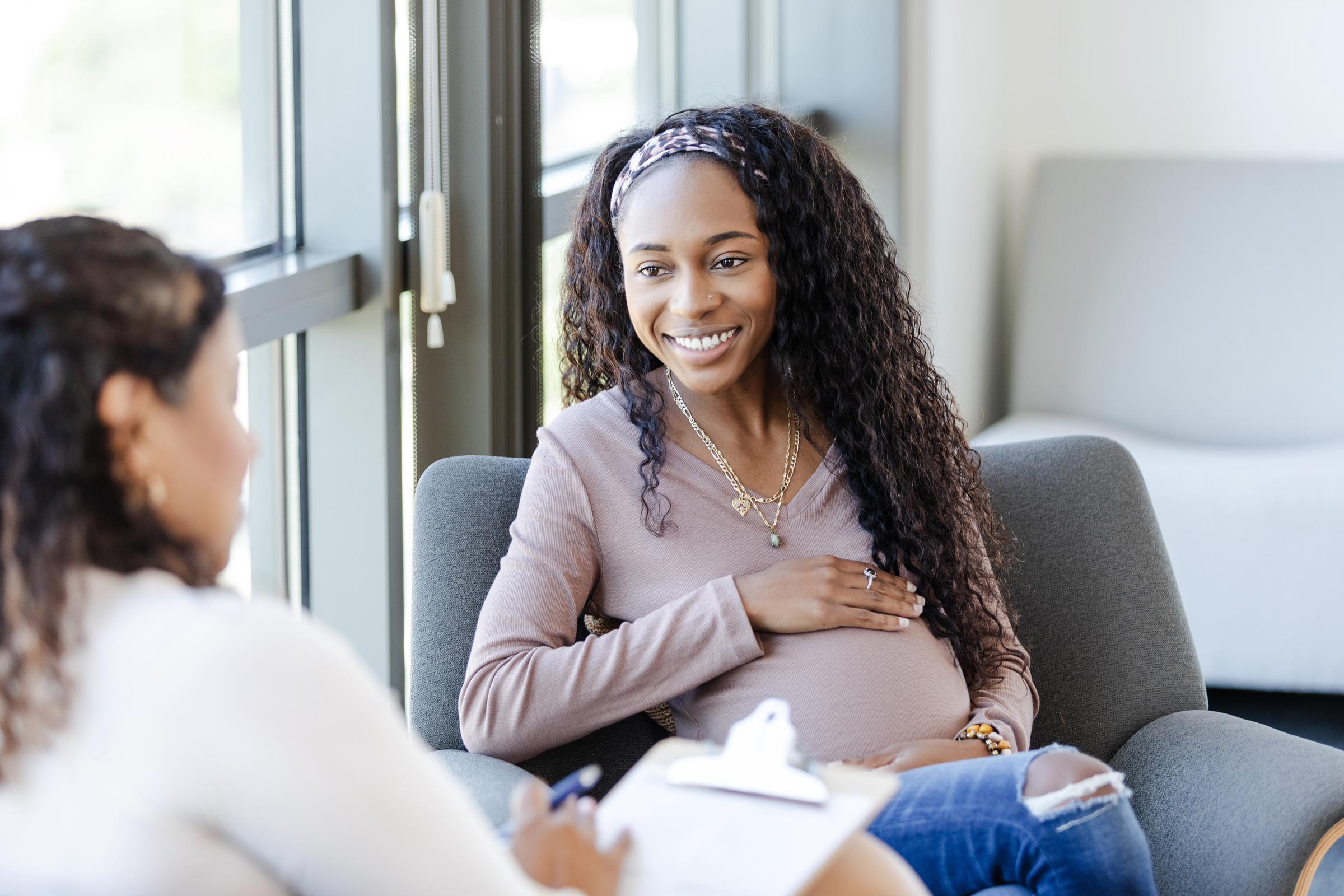 A pregnant woman talking to her doctor | Source: Getty Images