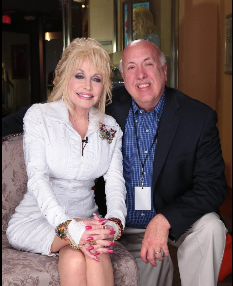 Jimmy Carter poses with country music icon Dolly Parton during one of his many celebrity encounters throughout his decades-long career as an entertainment reporter. | Source: Facebook/Melanie Layden