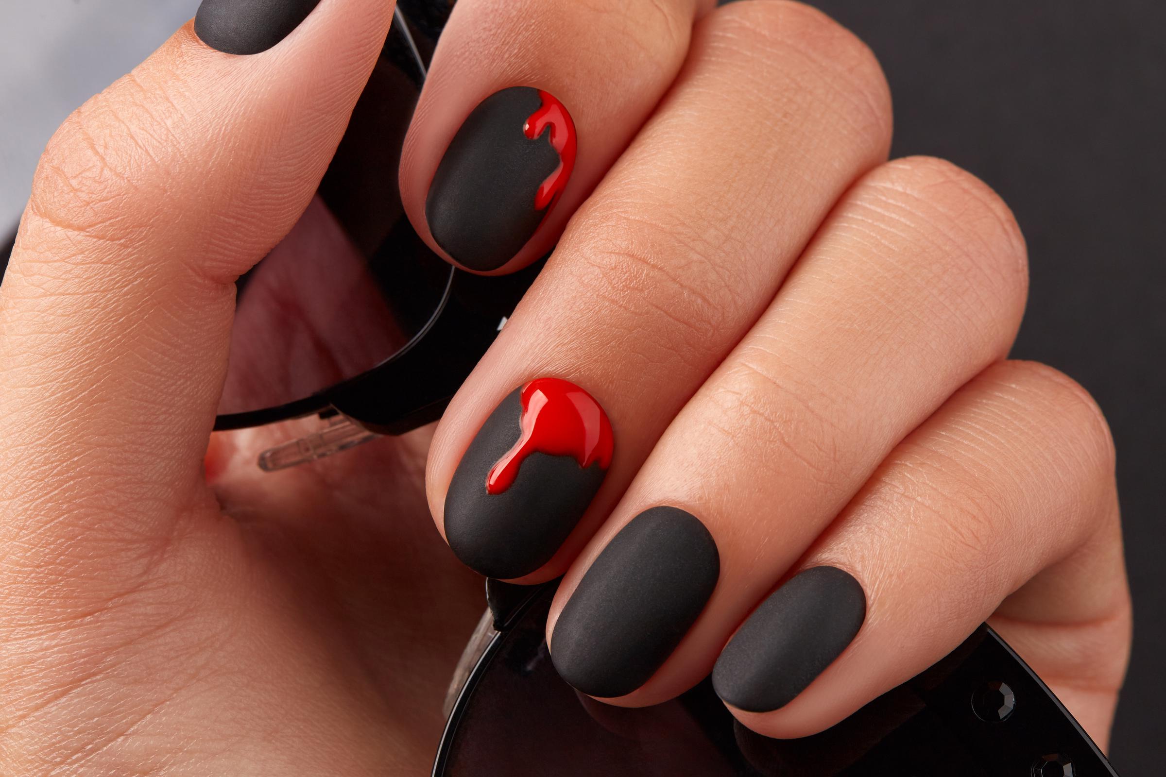 A close up of a woman's hand with a Halloween manicure. | Source: Getty Images