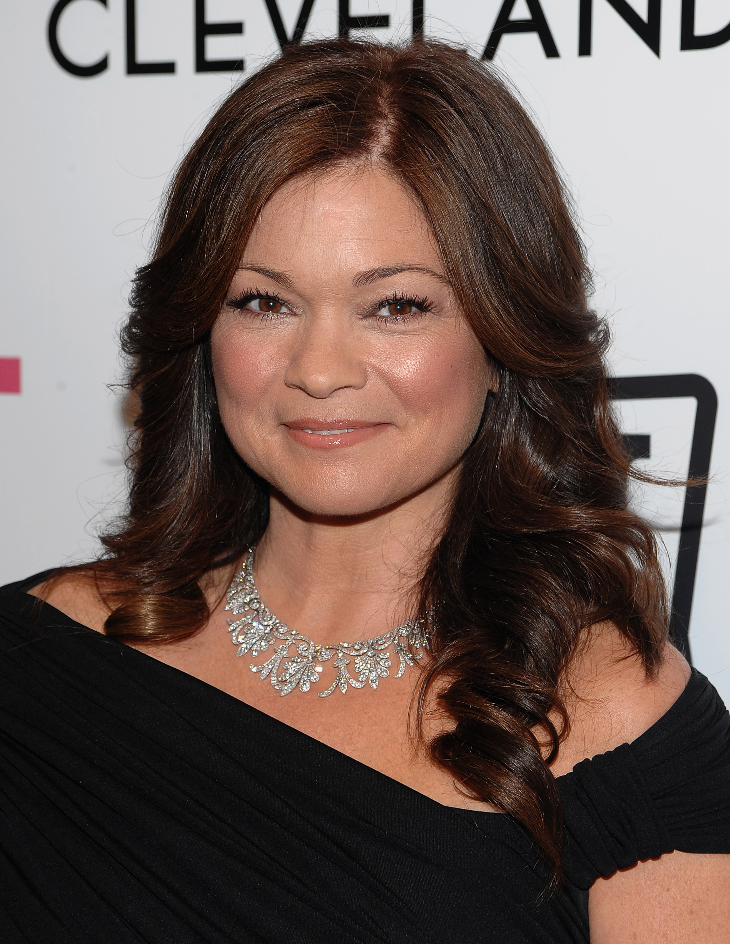 Valerie Bertinelli attends the "Hot in Cleveland" premiere at the Crosby Street Hotel in New York City. She returns to her brunette look, still parted in the middle, with softly curled edges that swirl gracefully over her shoulders.