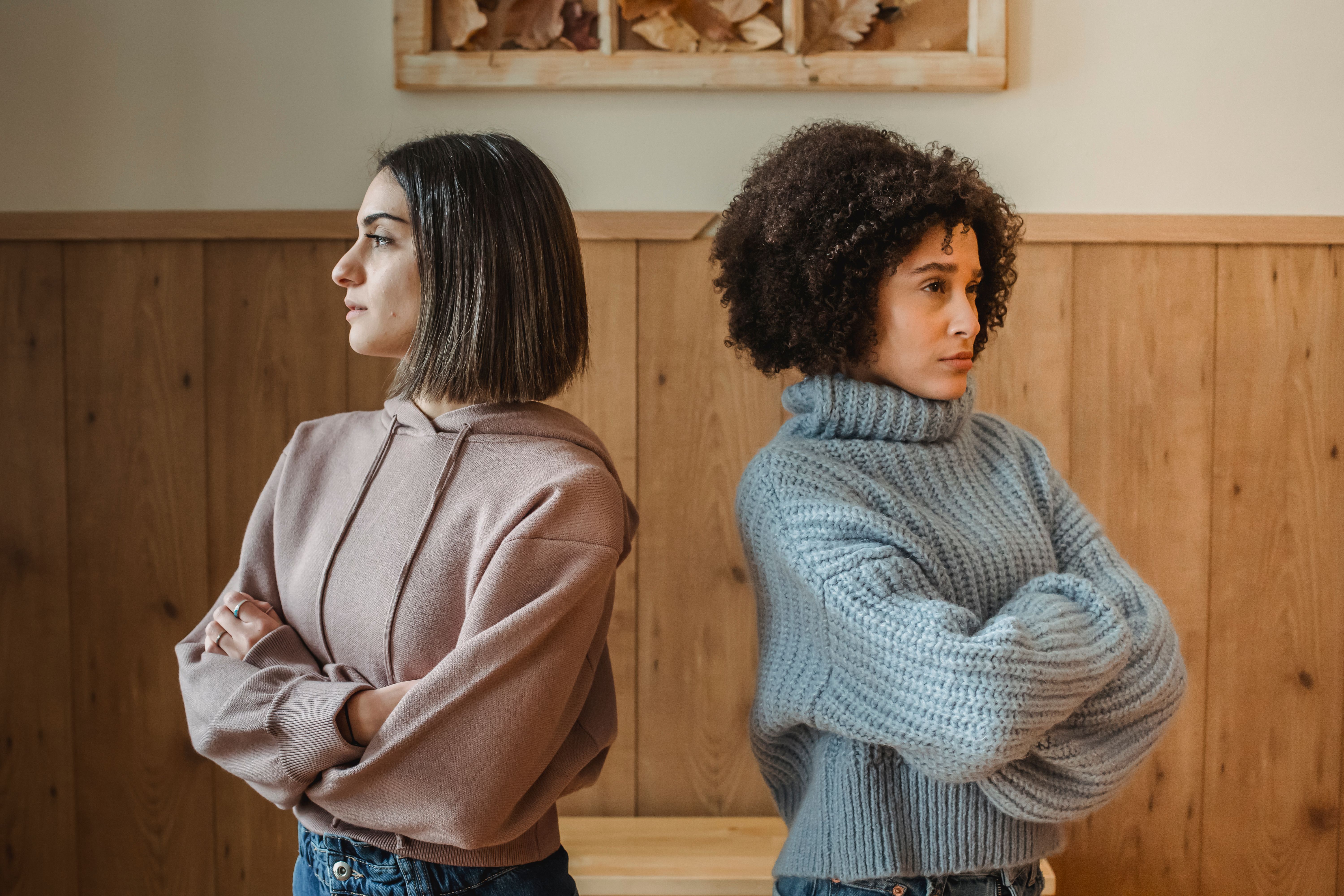 Two women at odds, their backs to each other | Source: Pexels