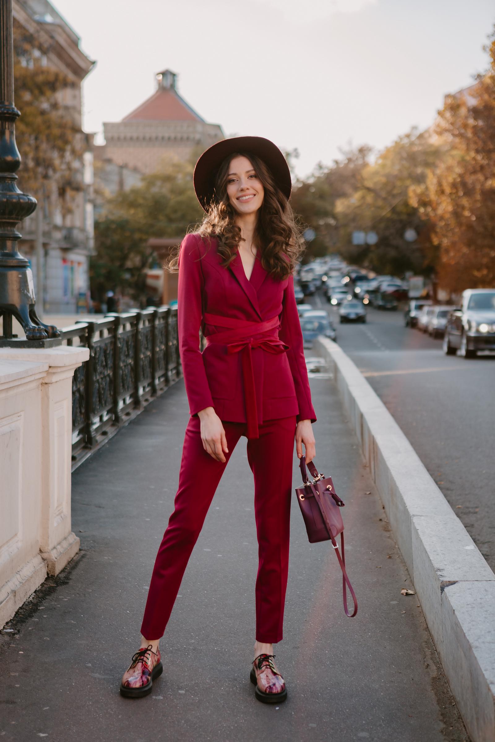 Sylish woman in a burgundy outfit | Source: Freepik