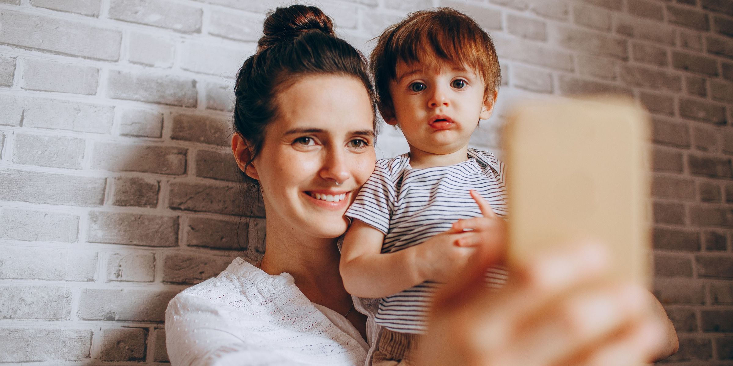A mother taking a selfie with her child | Source: Pexels