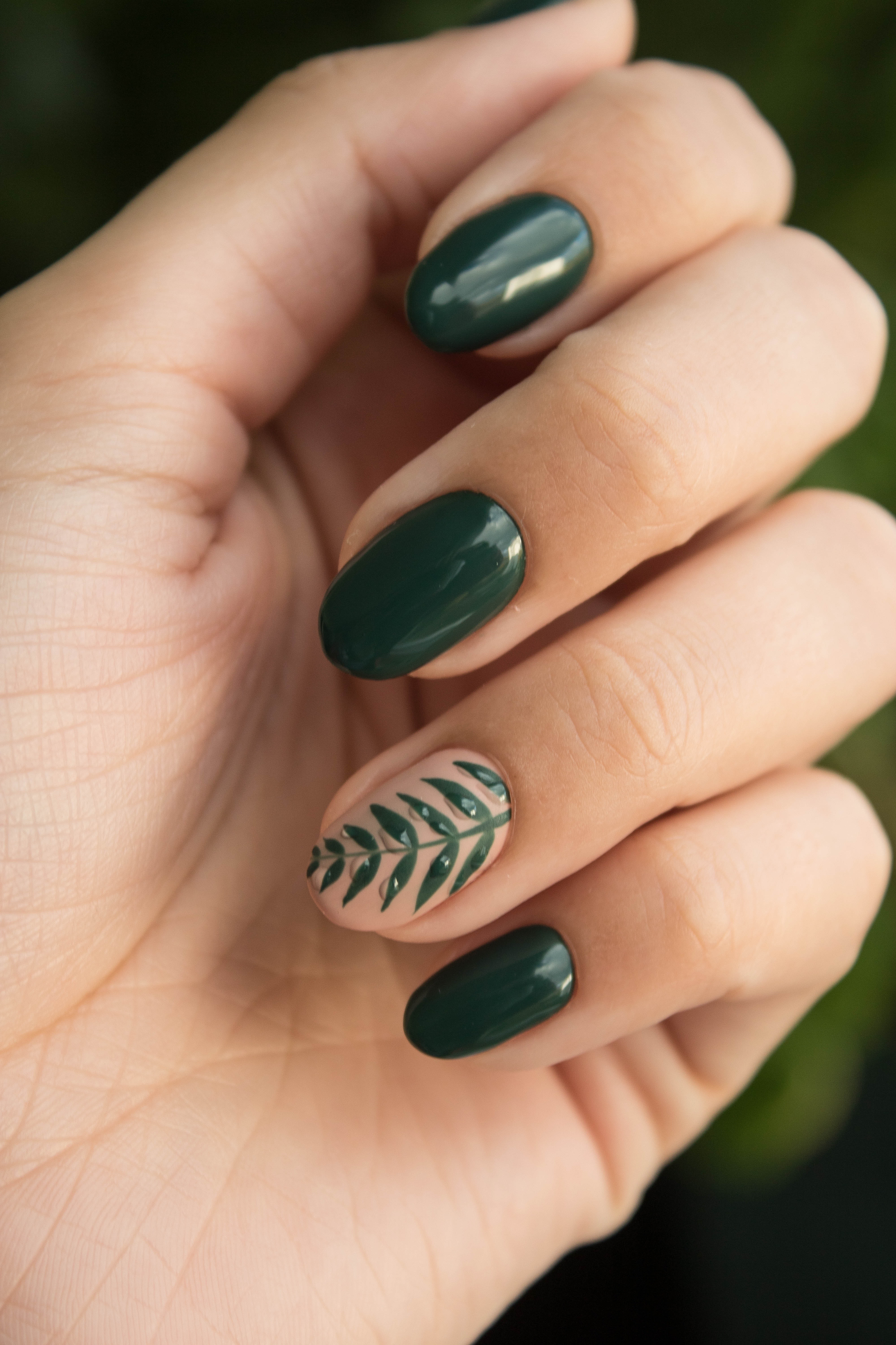 An close-up image of a well-manicured green nails. | Source: Pexels