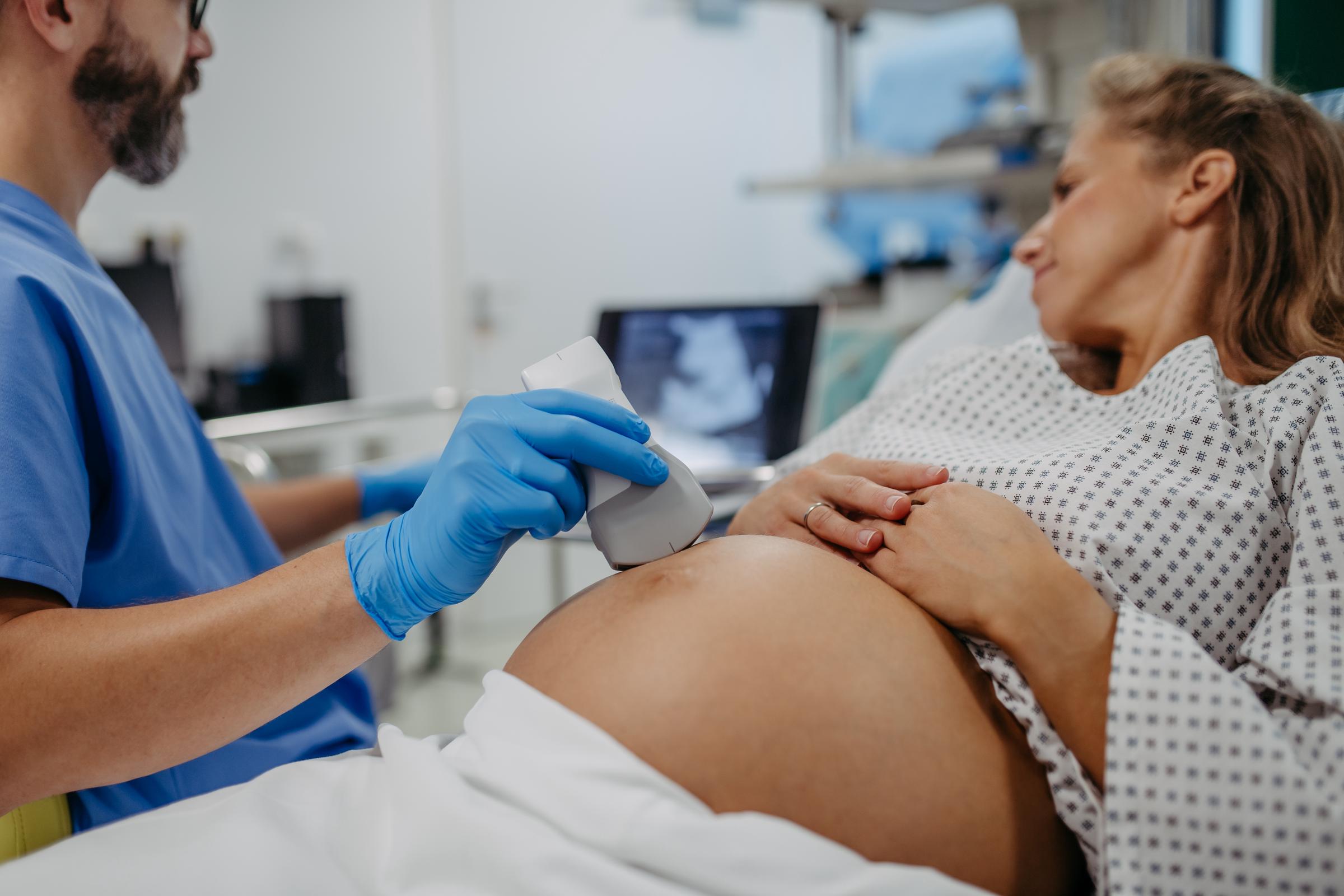 A doctor performing an ultrasound on a pregnant woman | Source: Getty Images