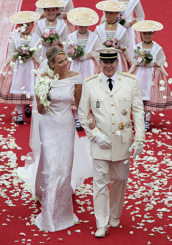 MONACO - JULY 02: Princess Charlene of Monaco and Prince Albert Of Monaco smile as they leave the palace after the religious ceremony of the Royal Wedding of Prince Albert II of Monaco to Charlene Wittstock in the main courtyard at Prince's Palace on July 2, 2011 in Monaco, Monaco. The Roman-Catholic ceremony follows the civil wedding which was held in the Throne Room of the Prince's Palace of Monaco on July 1. With her marriage to the head of state of the Principality of Monaco, Charlene Wittstock will become Princess consort of Monaco and gain the title, Princess Charlene of Monaco. Celebrations including concerts and firework displays are being held across several days, attended by a guest list of global celebrities and heads of state. (Photo by Andreas Rentz/Getty Images)