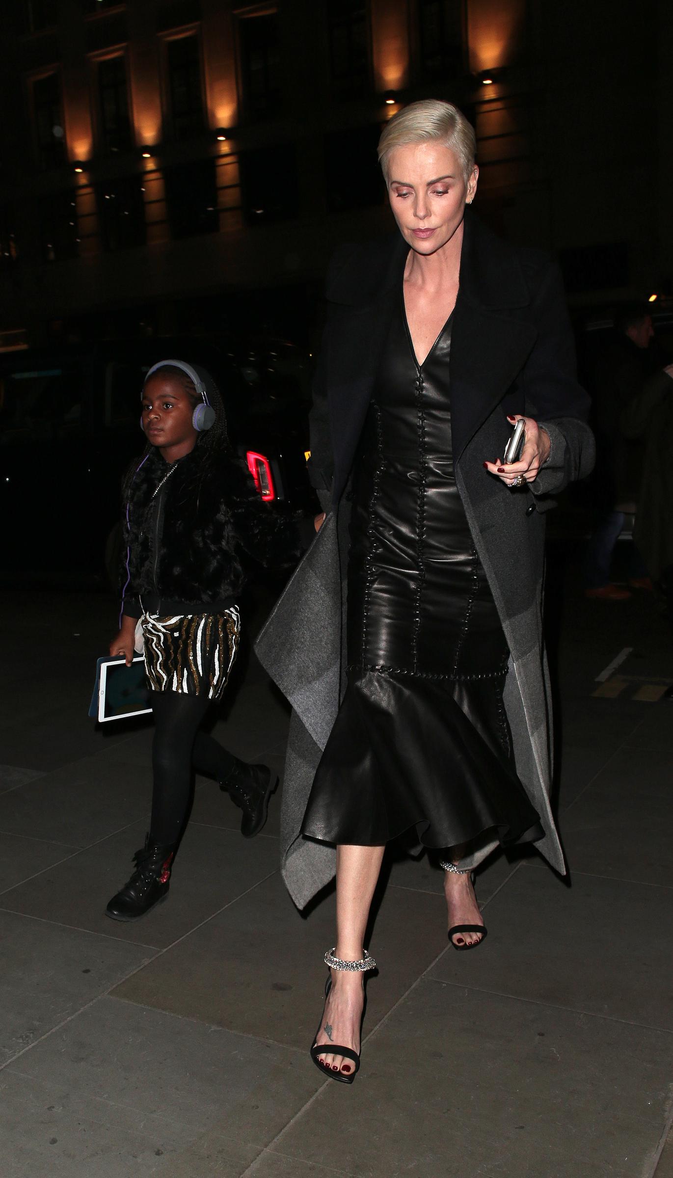 Charlize Theron spotted out with one of her daughters in London, England on December 3, 2019.