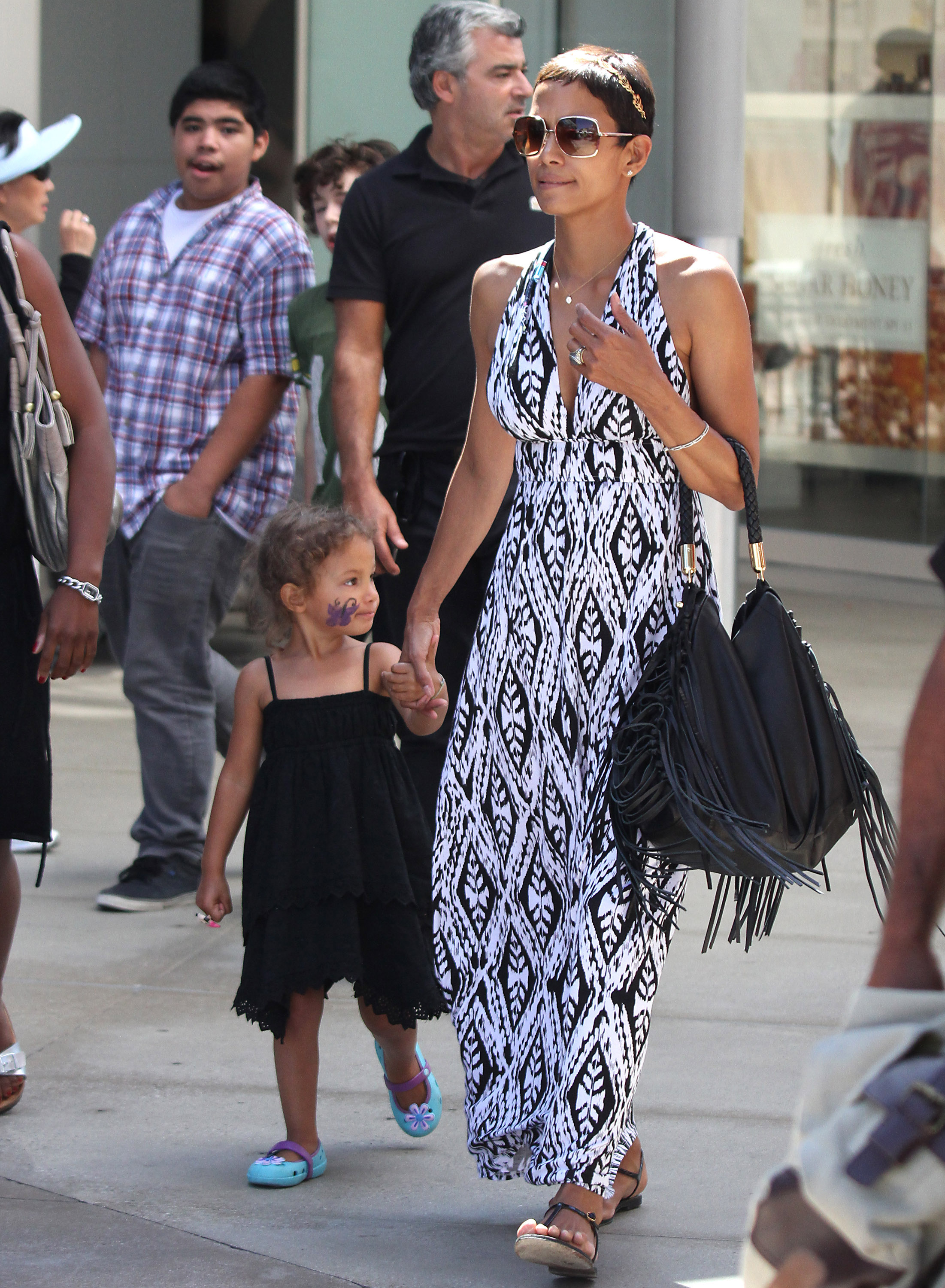 Little Nahla had a purple butterfly painted on her cheek as she walked hand in hand with Halle Berry during a shopping outing. | Source: Getty Images.