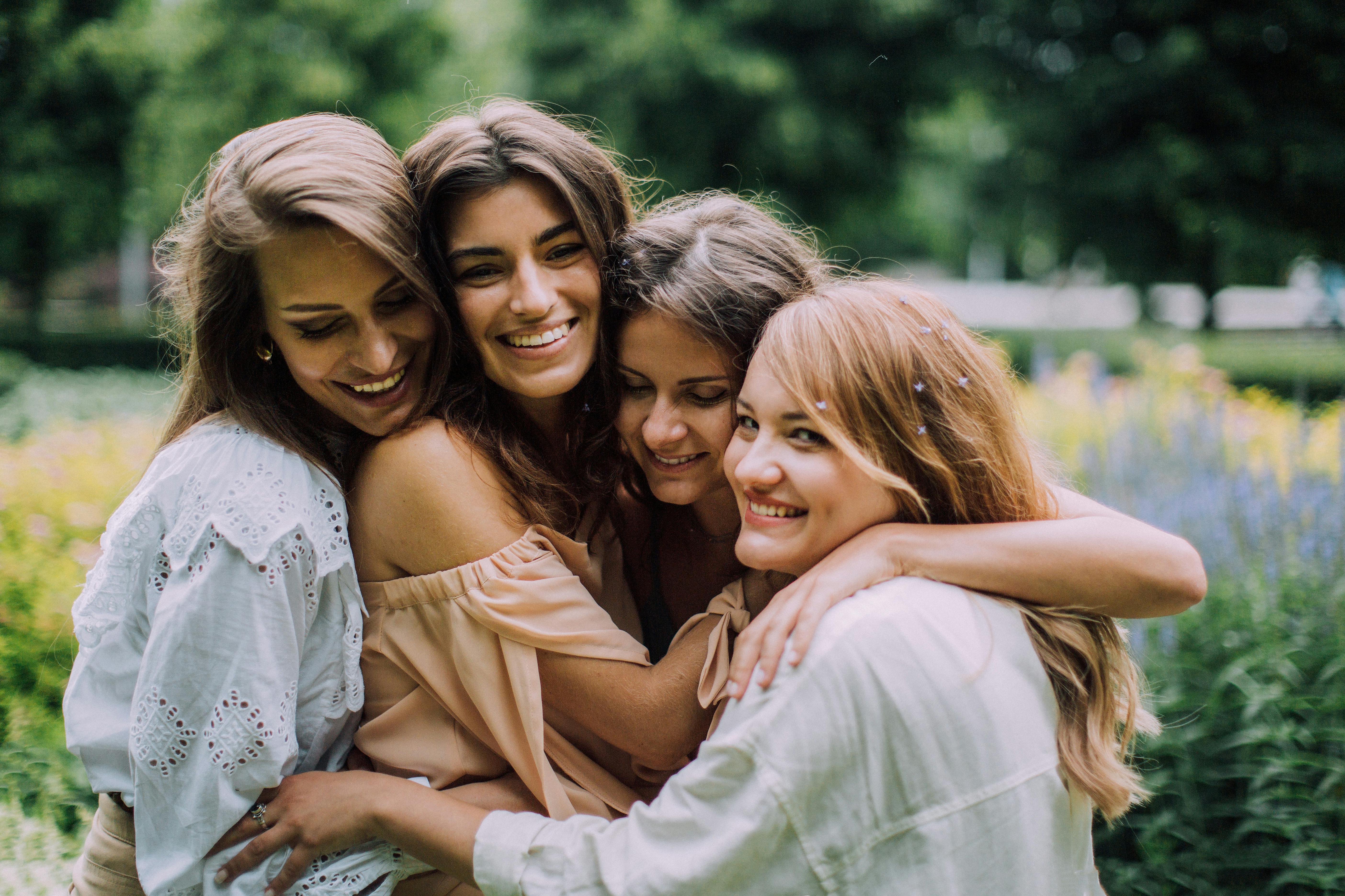 A group of female friends smiling and embracing ech other | Source: Pexels