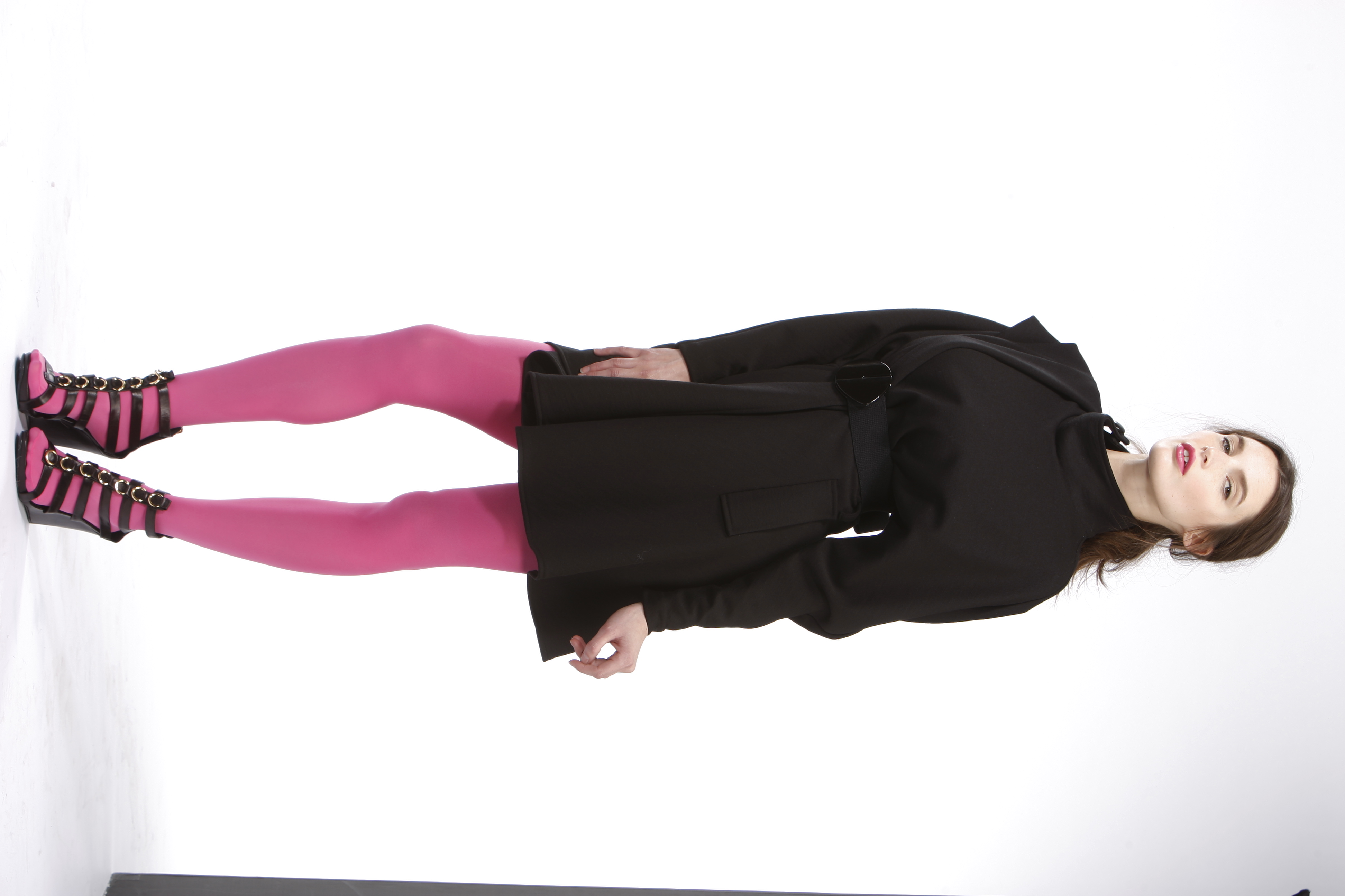 A woman wearing pink tights with an all-black ensemble | Source: Getty Images