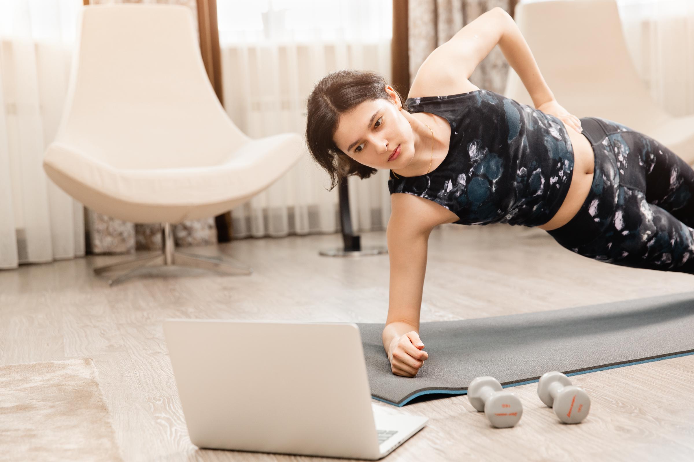 Woman doing online workout at home | Source: Shutterstock