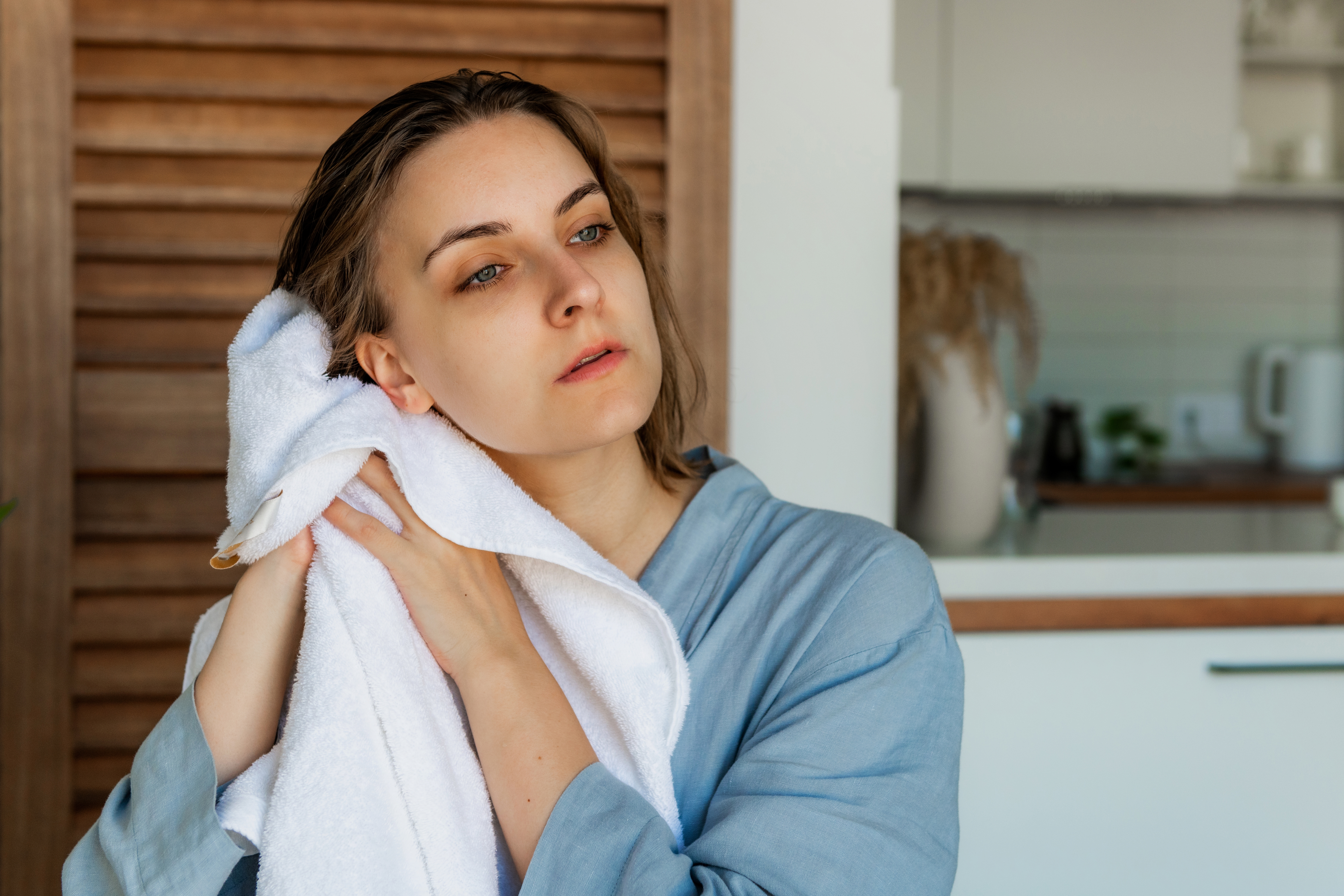 A woman is pictured drying her hair after a shower | Source: Shutterstock