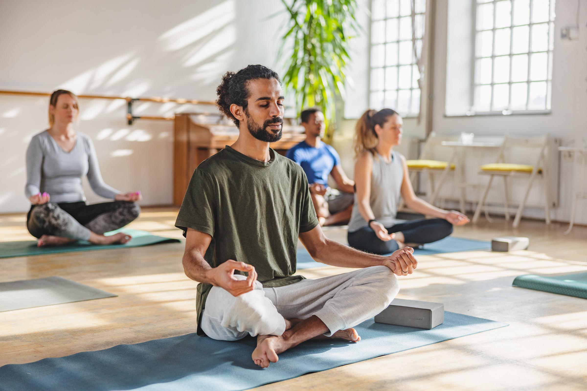 A group of people doing yoga at a studio | Source: Getty Images