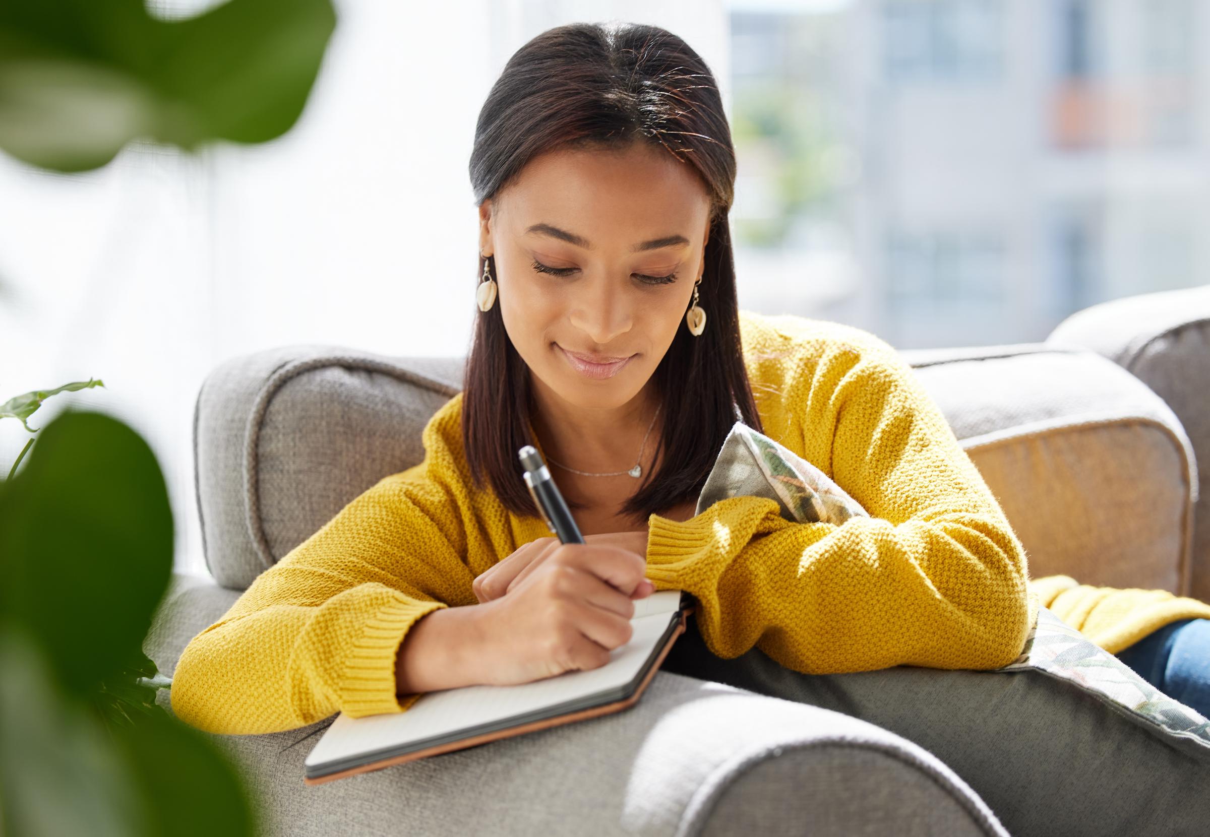 A young woman journaling | Source: Shutterstock
