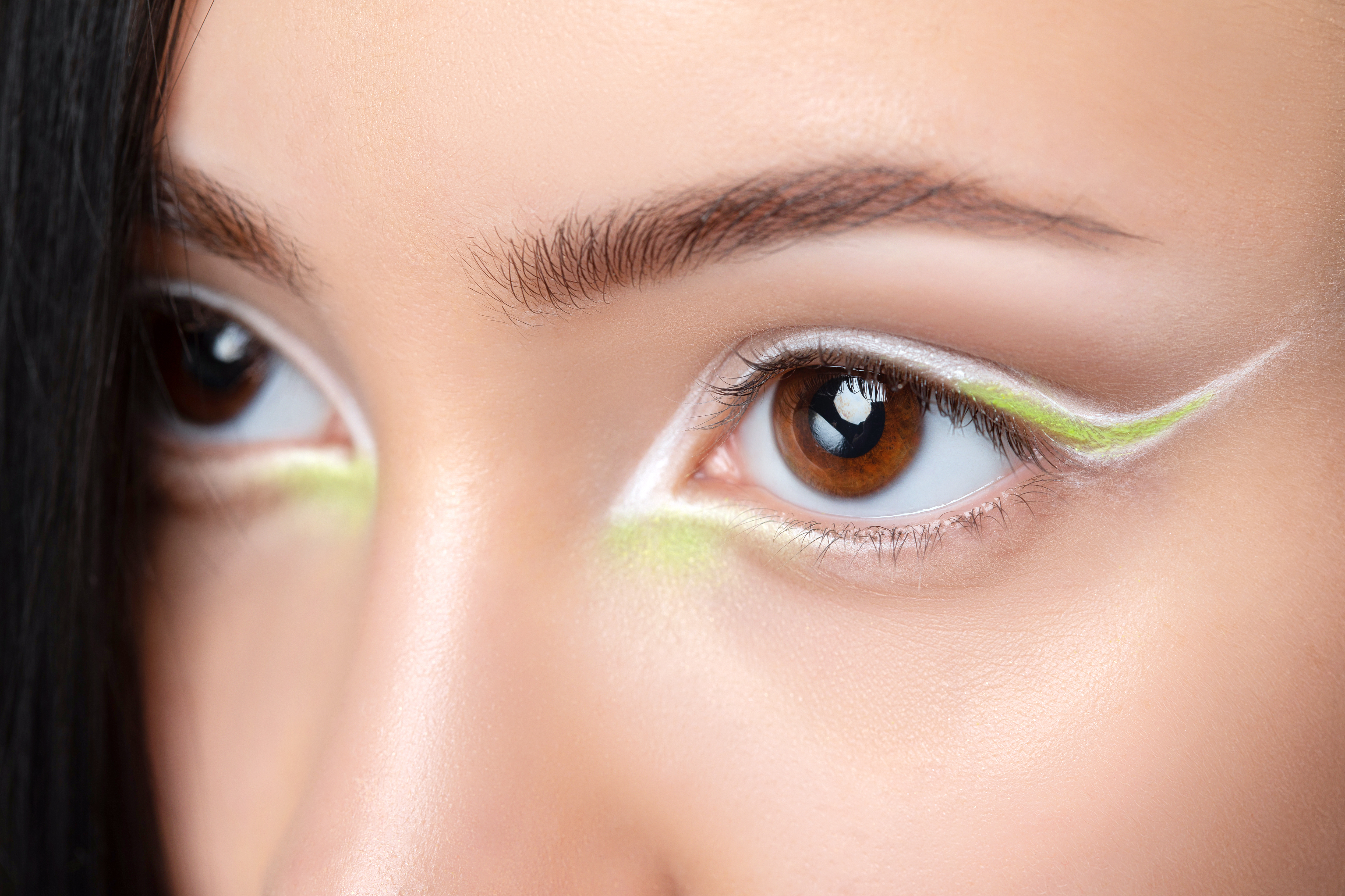 A model with green and white eye makeup. | Source: Getty Images