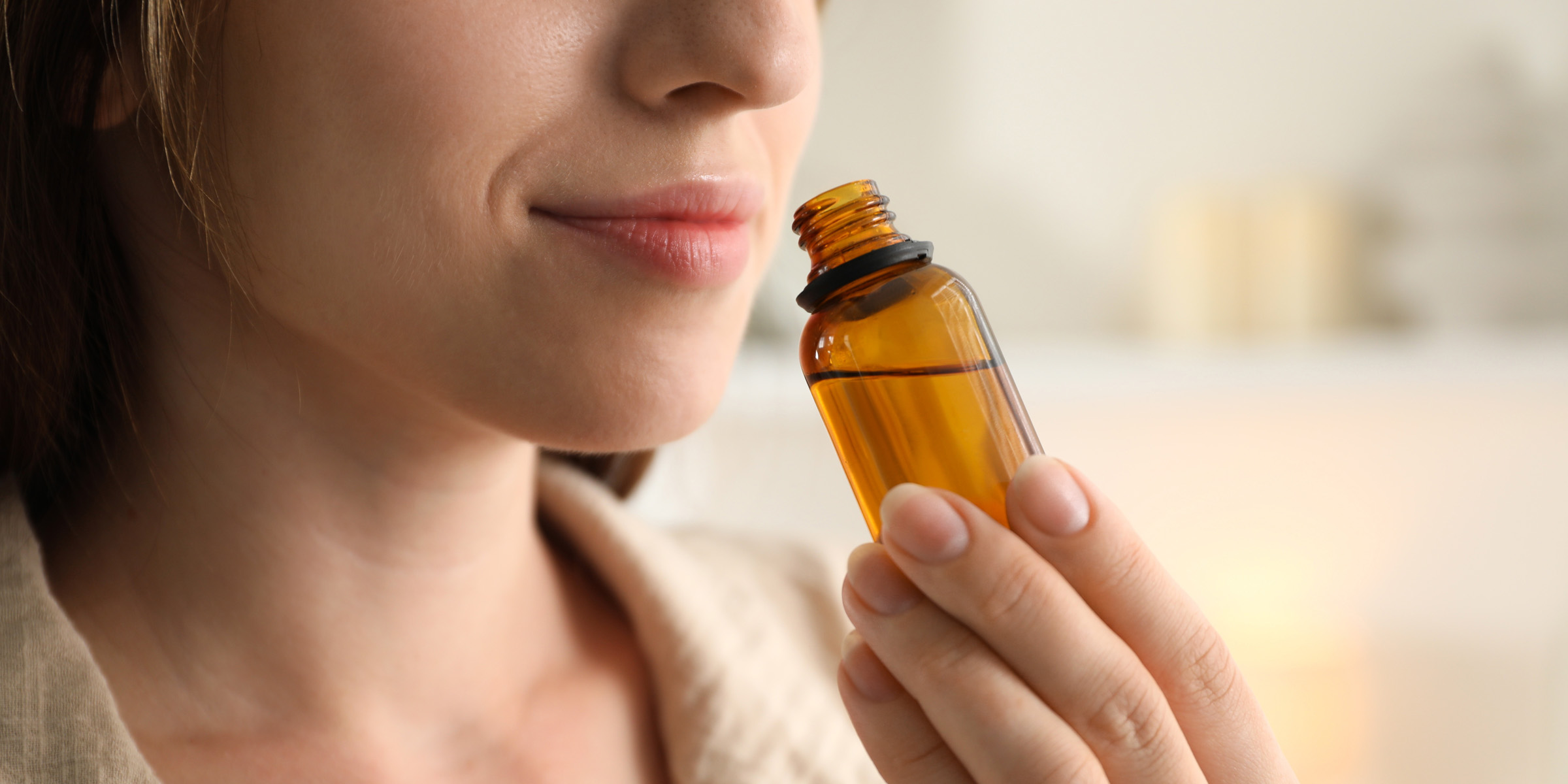 Woman feeling the scent of a diffuser | Source: Shutterstock