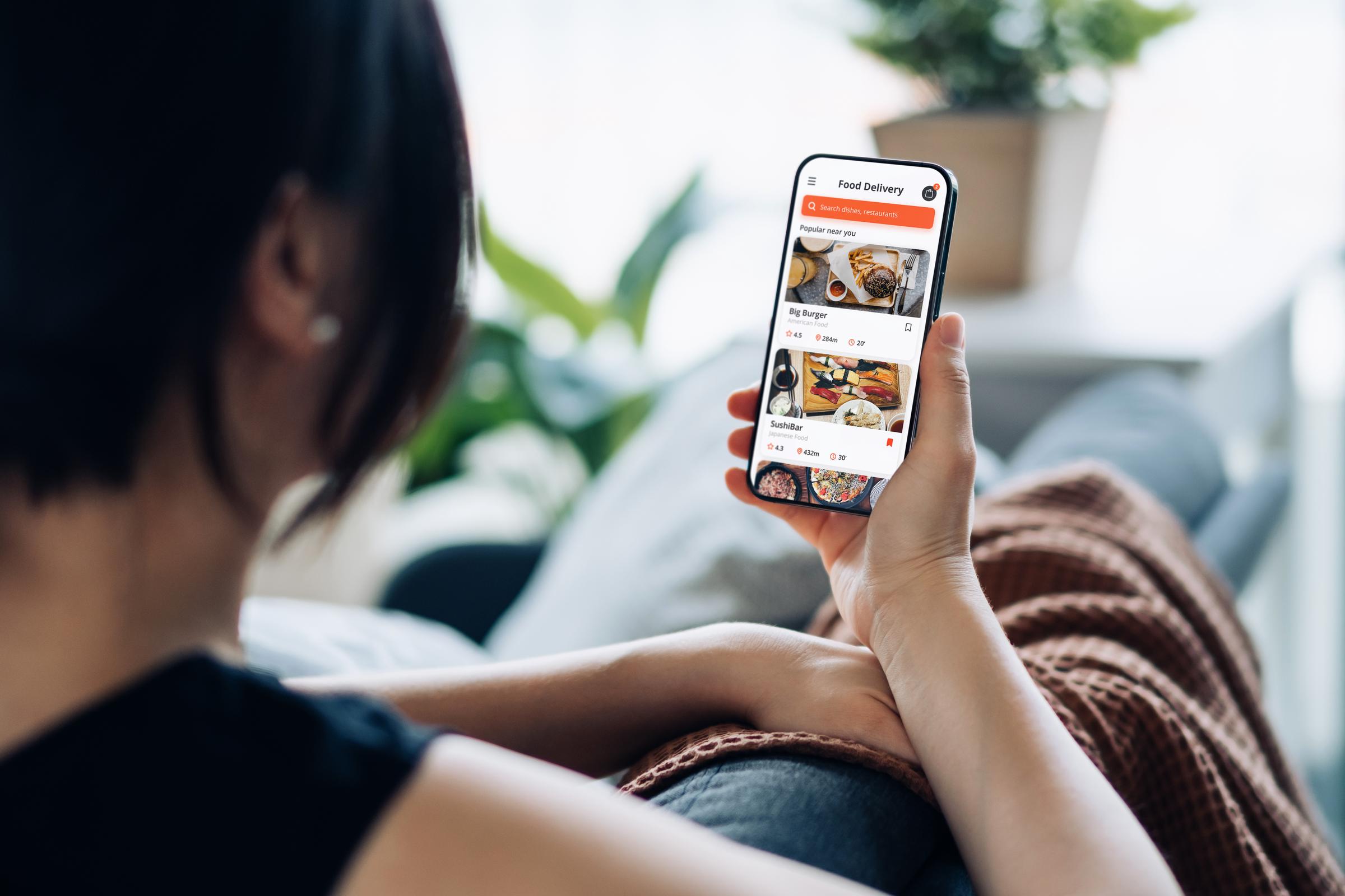 A woman browsing a food delivery app | Source: Getty Images