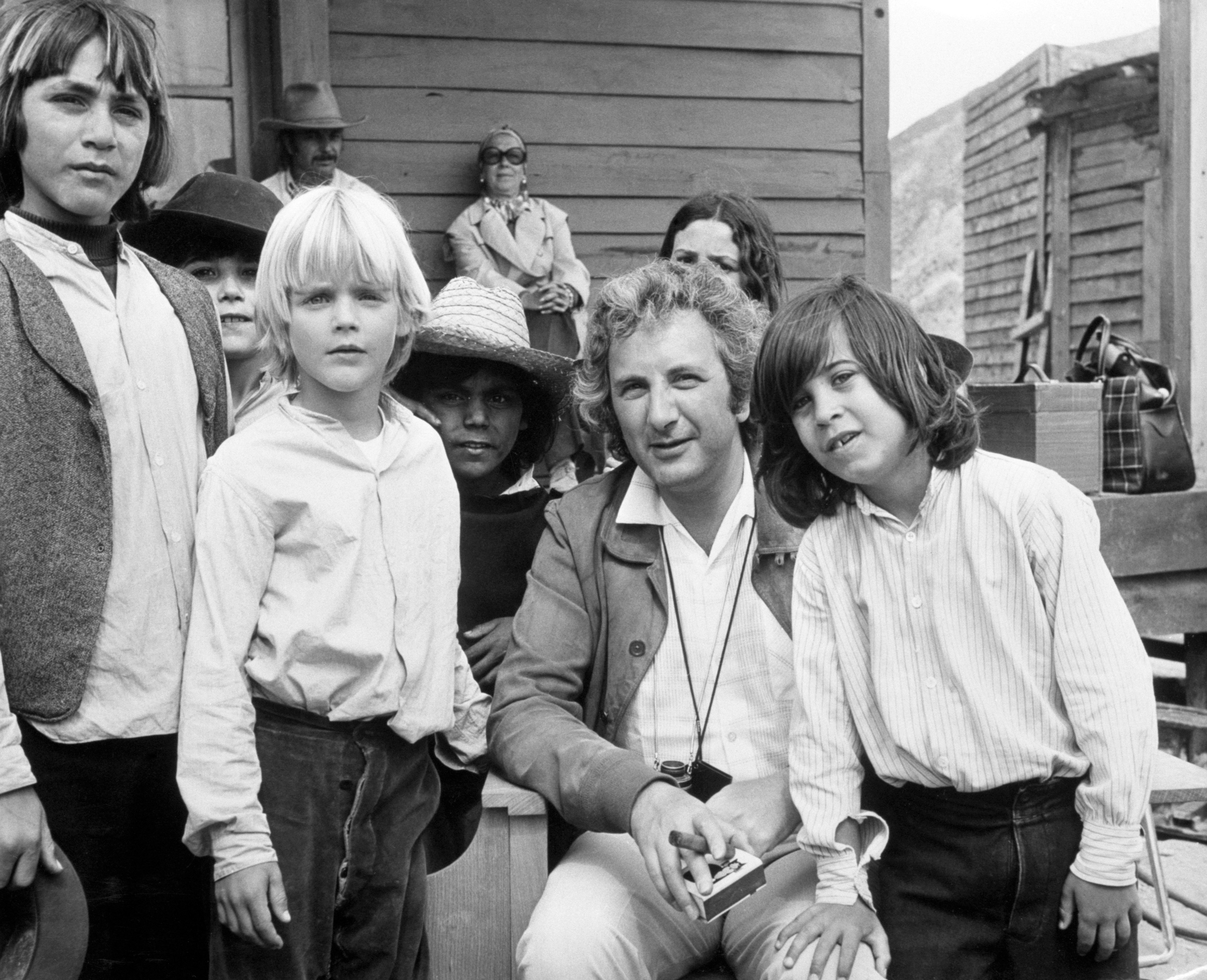 Director Michael Winner poses on the set of "Chato's Land" with young actors, including Jill Ireland and David McCallum's sons Jason, right, and Valentine, center. | Source: Getty Images