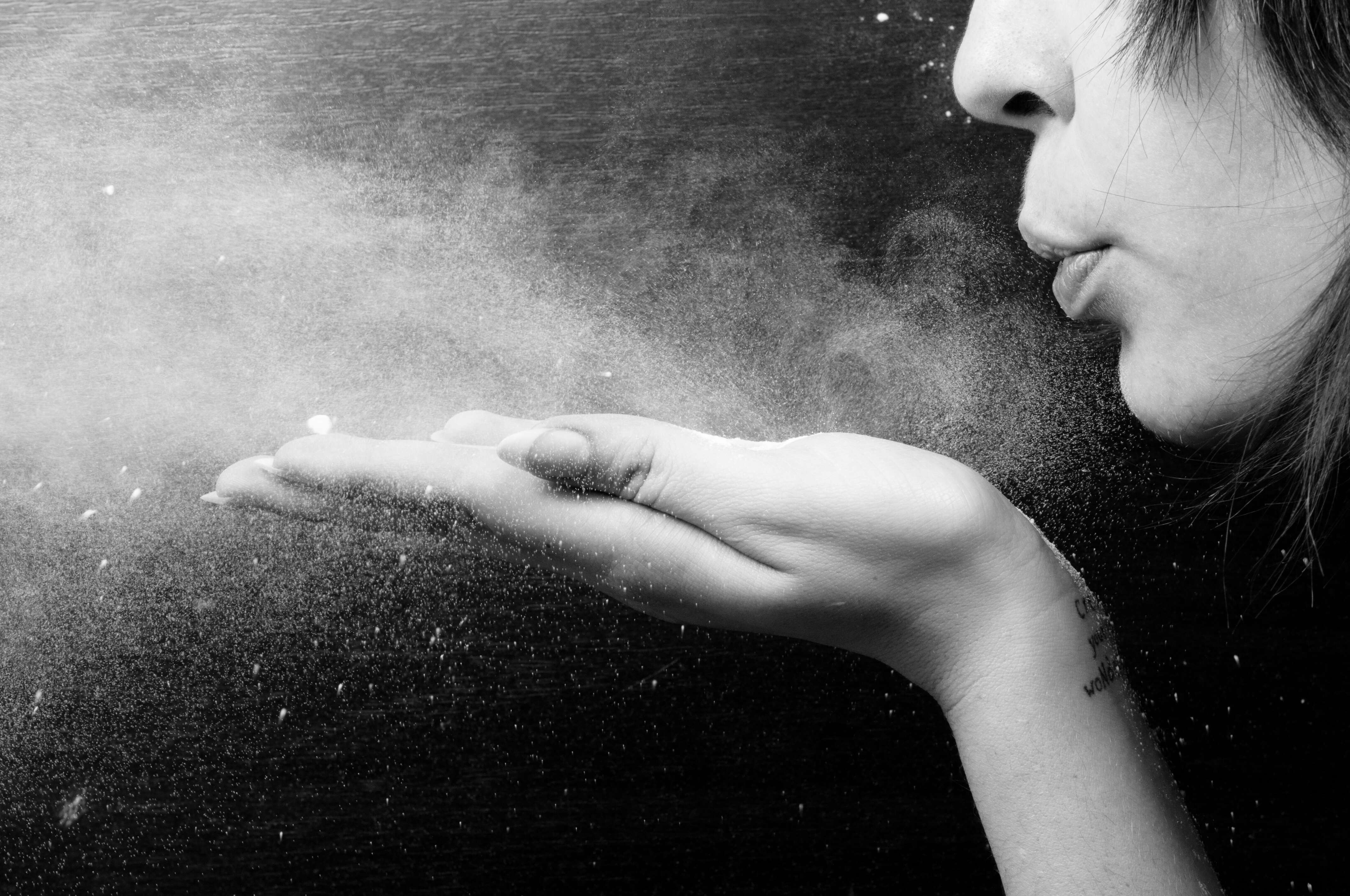 Photo of a woman blowing cinnamon powder into her home | Source: Shutterstock