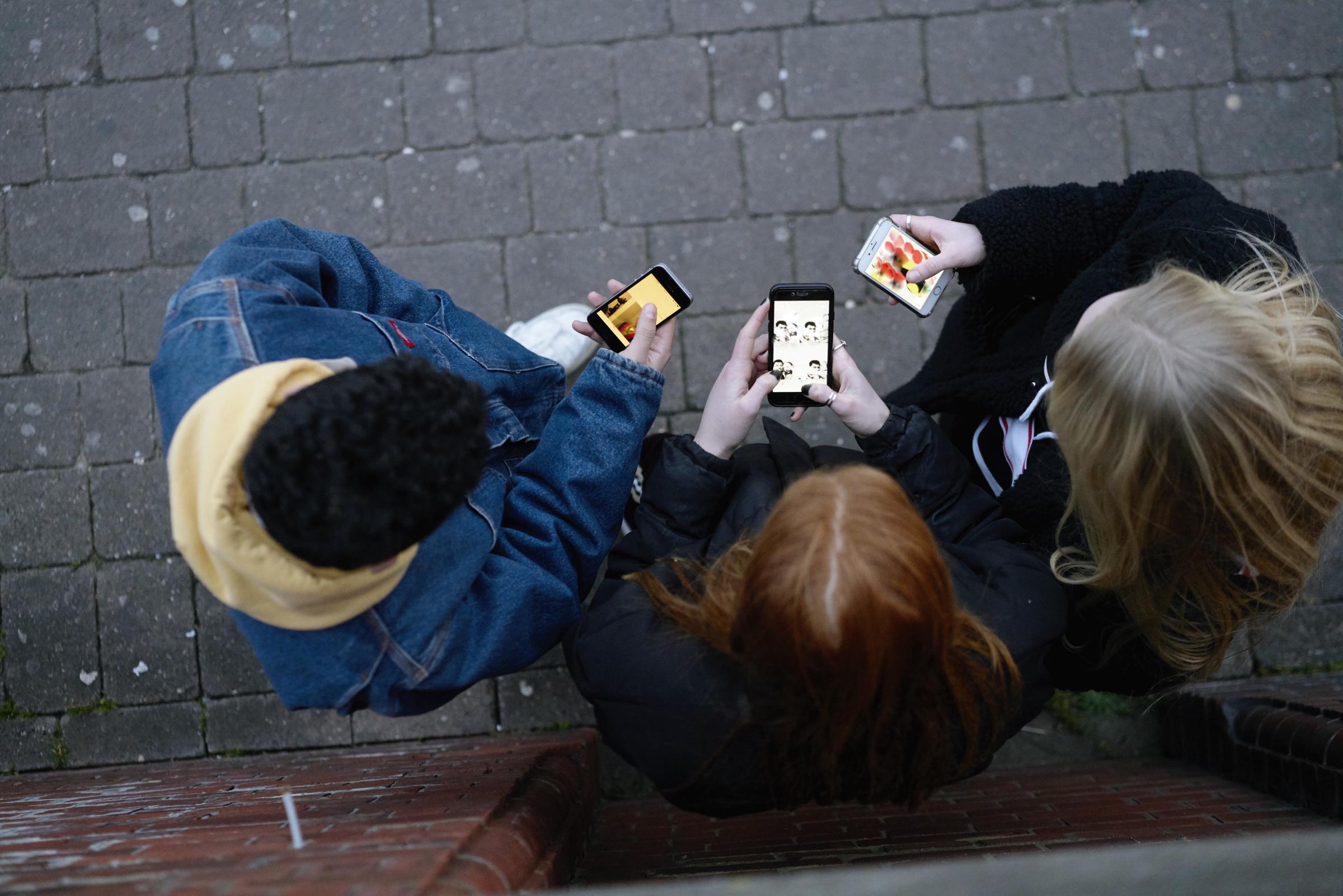 A group of friends on their phones | Source: Getty Images
