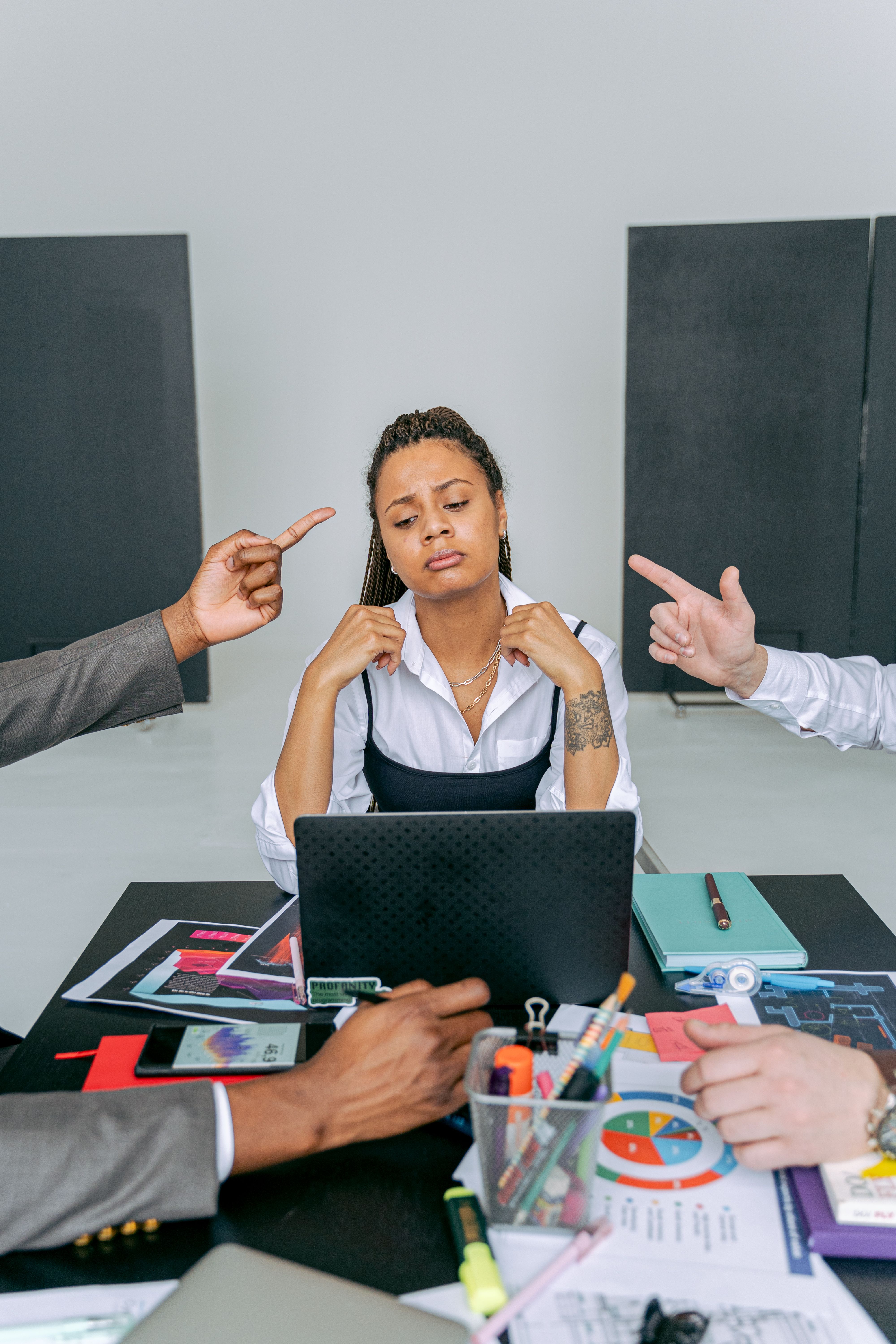 Woman appearing overwhelmed during an office meeting | Source: Pexels