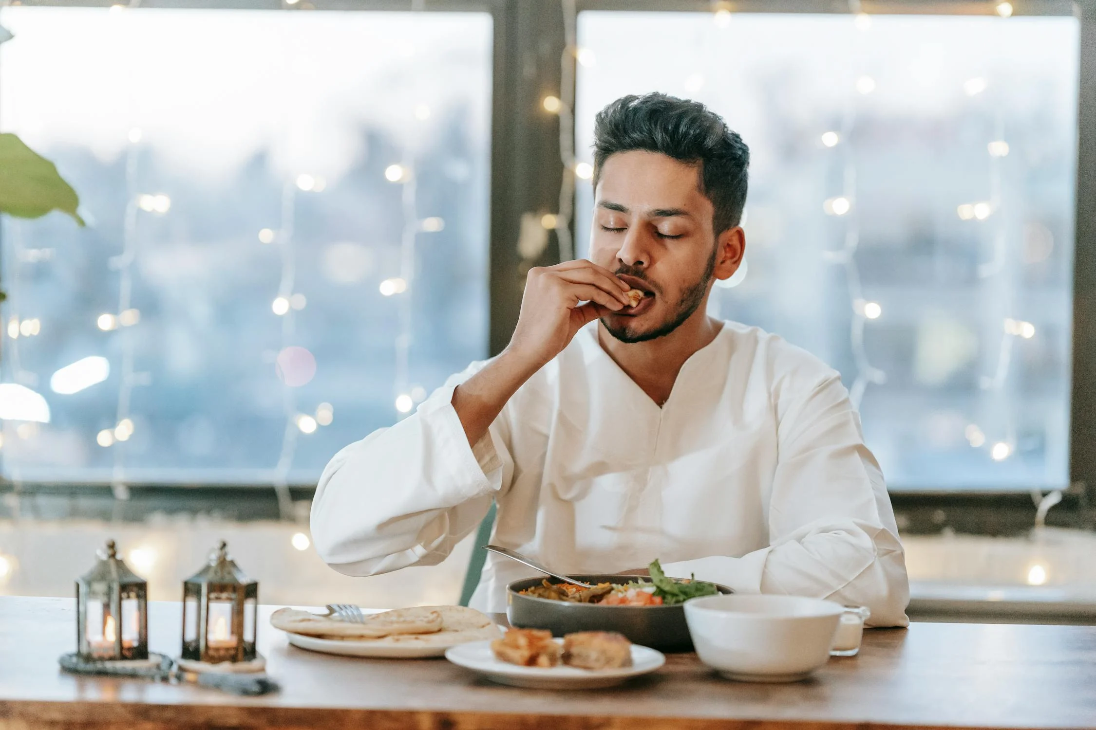 Um homem comendo com as mãos | Fonte: Pexels