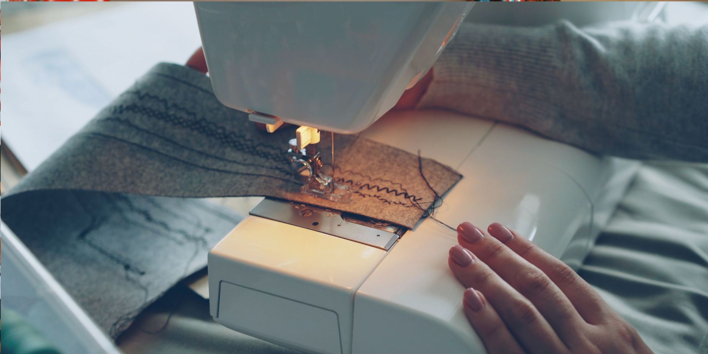 Close-up of a sewing machine stitching through fabric | Source: Pexels