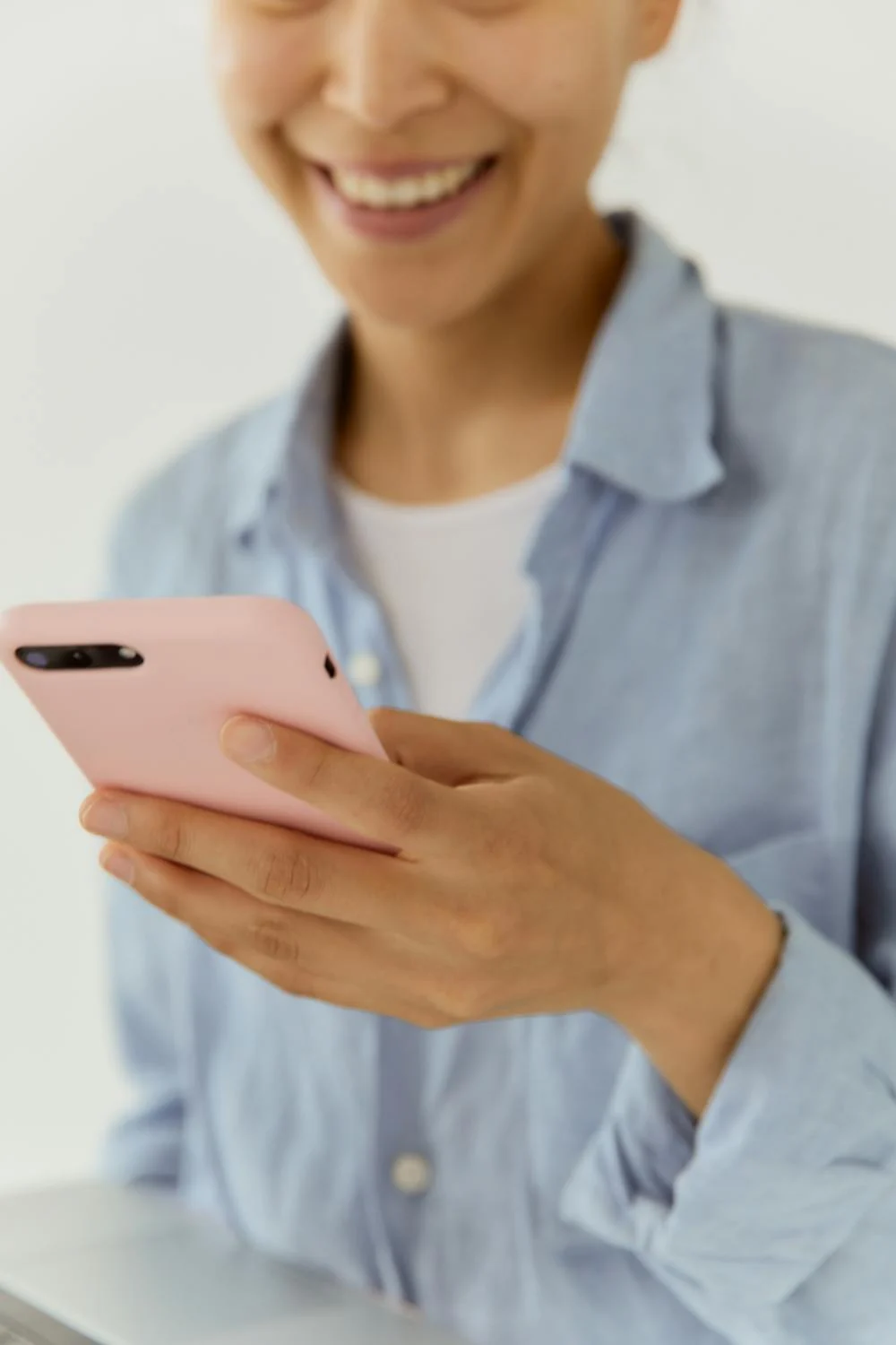 A laughing woman on her phone | Source: Pexels