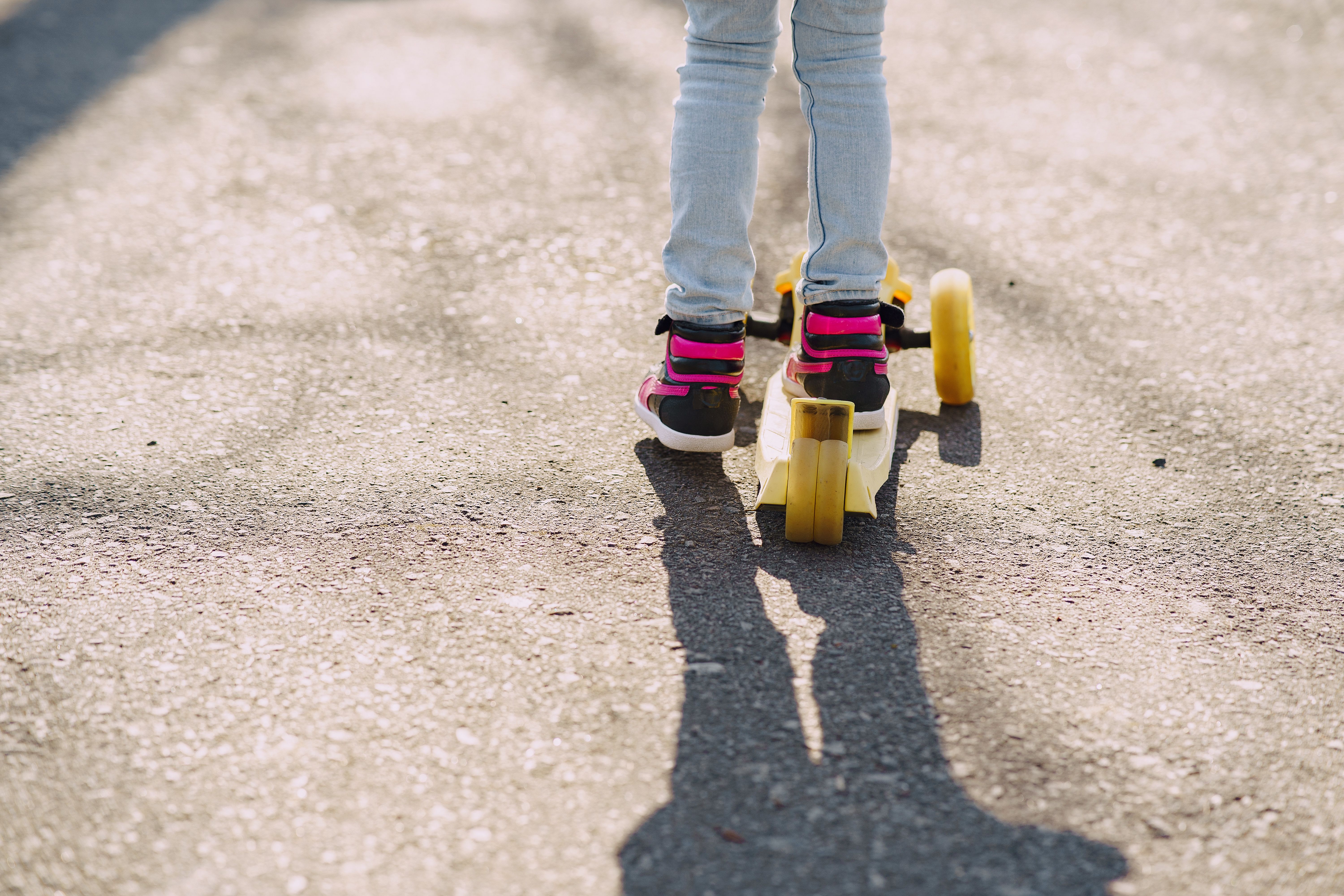 A child riding a scooter outdoors | Source: Pexels